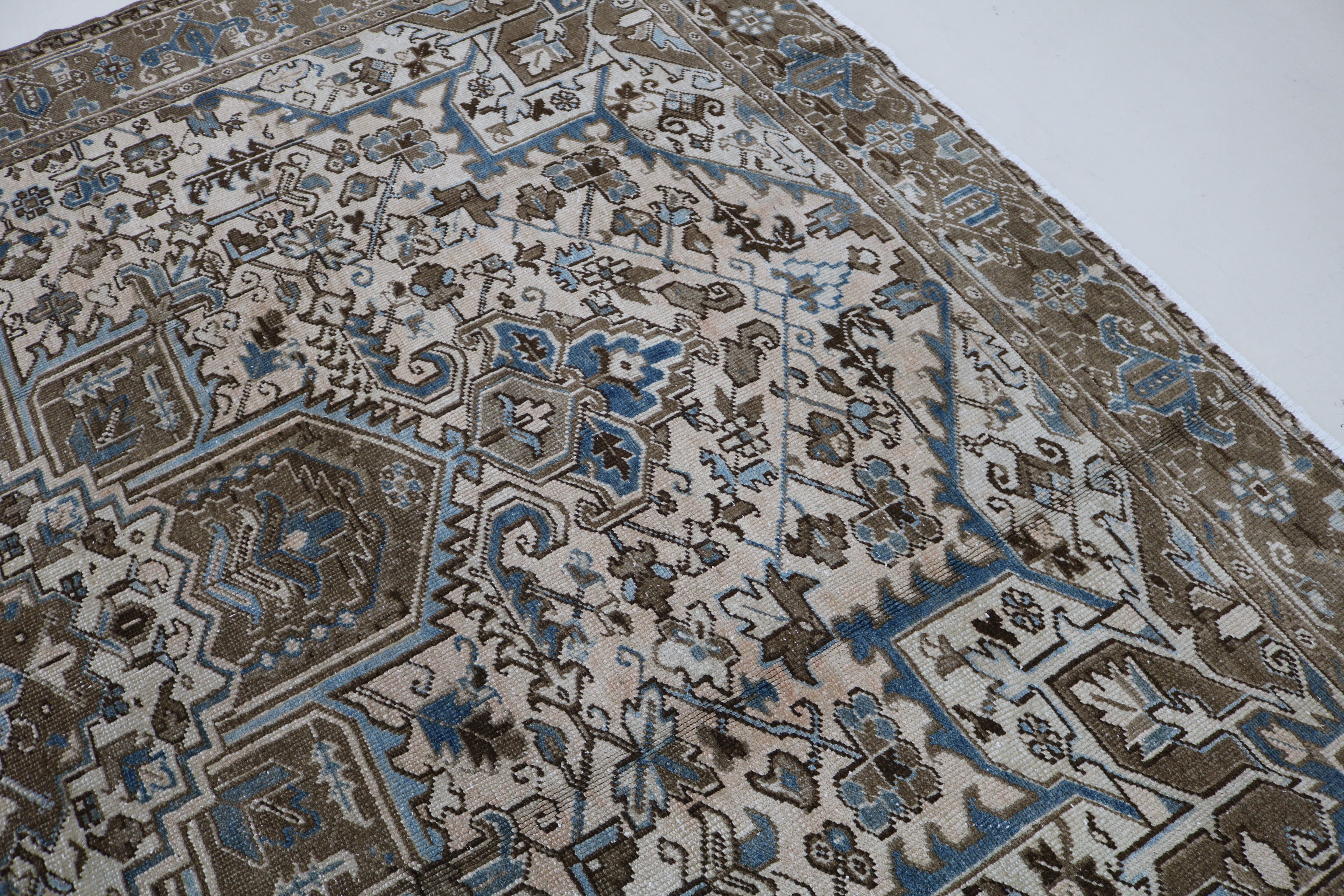 Close-up of hand-knotted wool texture on decorative antique Heriz carpet