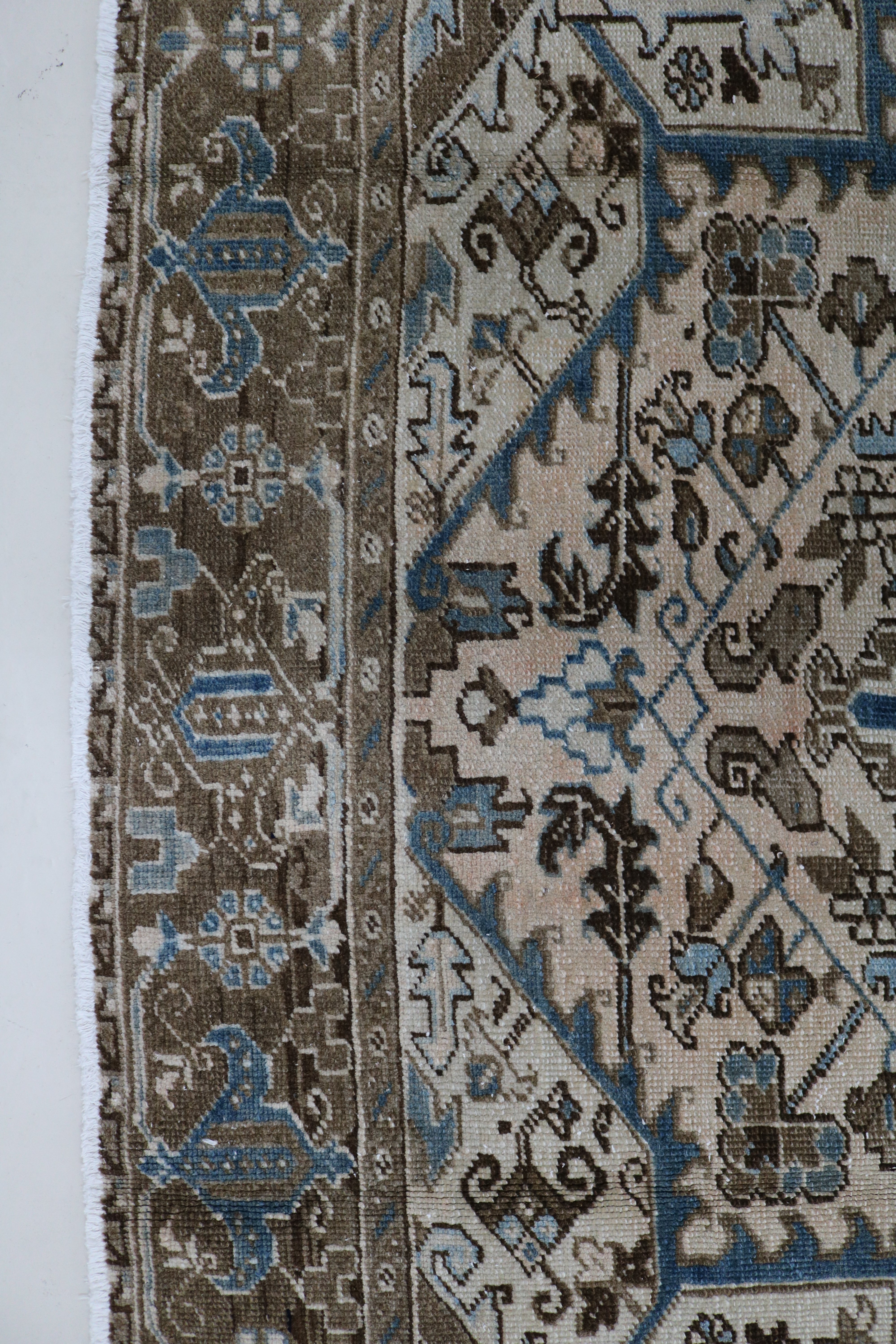 Close-up of hand-knotted wool texture on decorative antique Heriz carpet