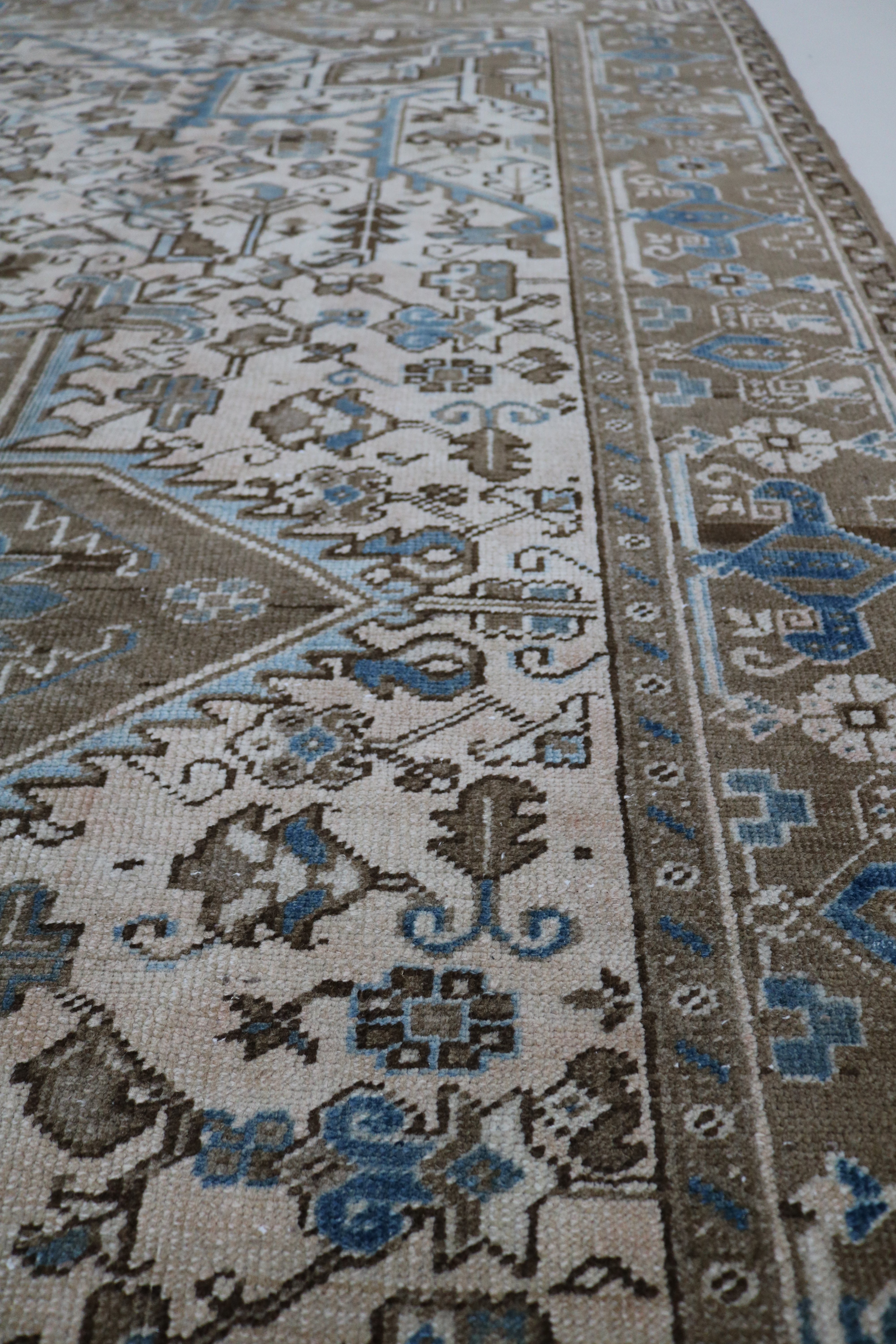 Close-up of hand-knotted wool texture on decorative antique Heriz carpet
