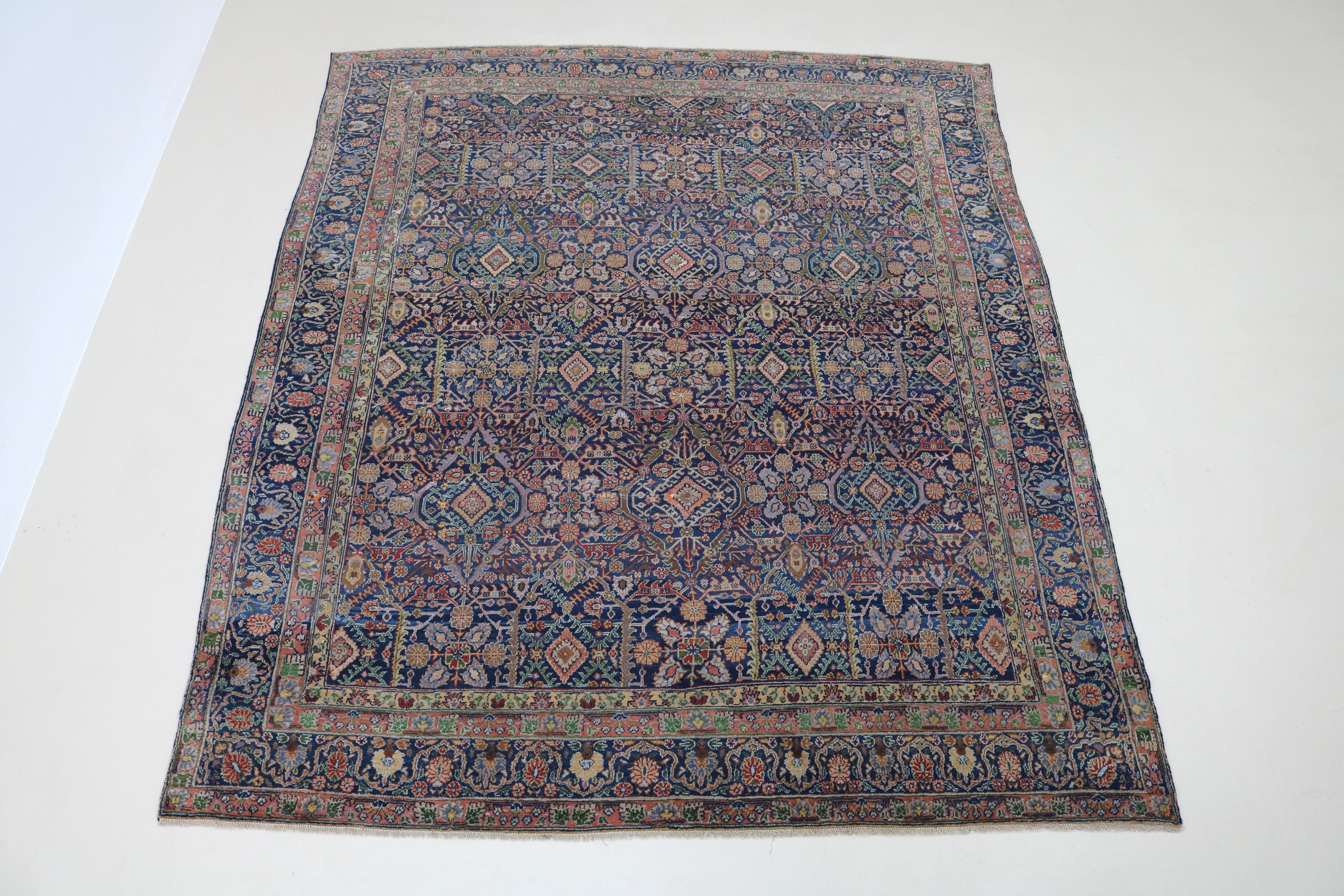 Full view of antique Persian Senneh carpet with intricate floral lozenge design