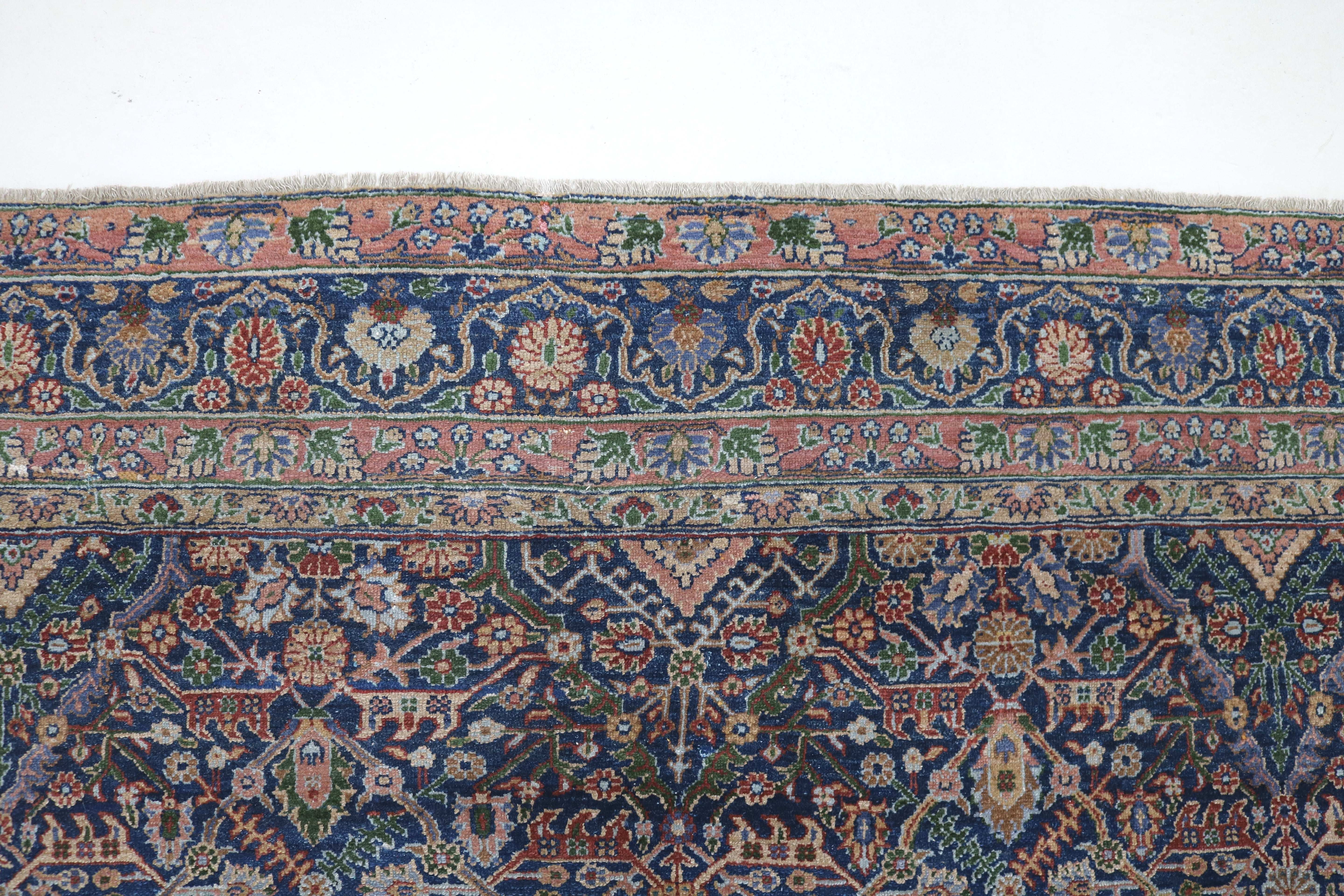 Close-up of finely woven wool texture on antique Persian Senneh carpet