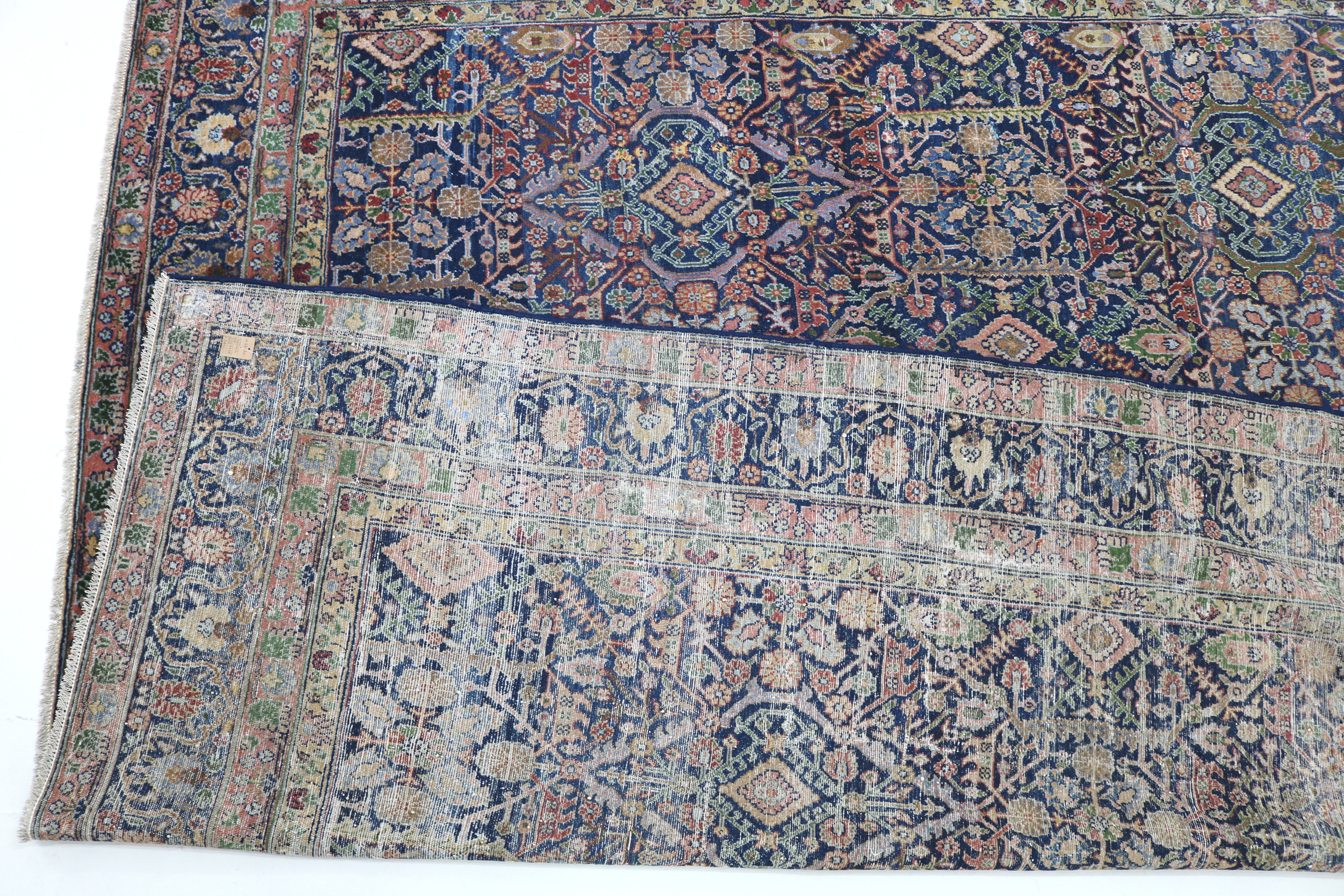 Close-up of finely woven wool texture on antique Persian Senneh carpet