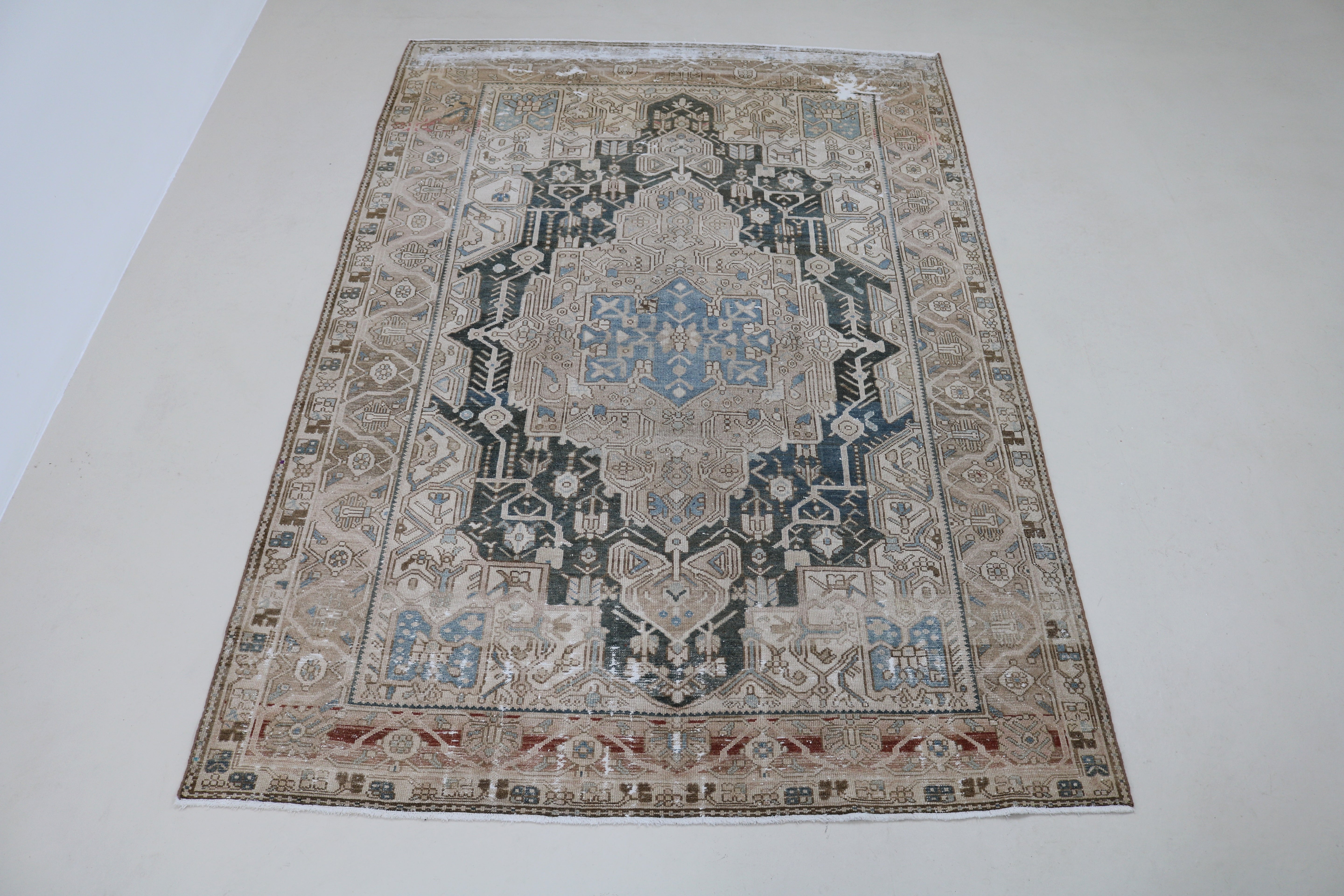 Full view of antique Persian Karaja carpet with striking tribal design
