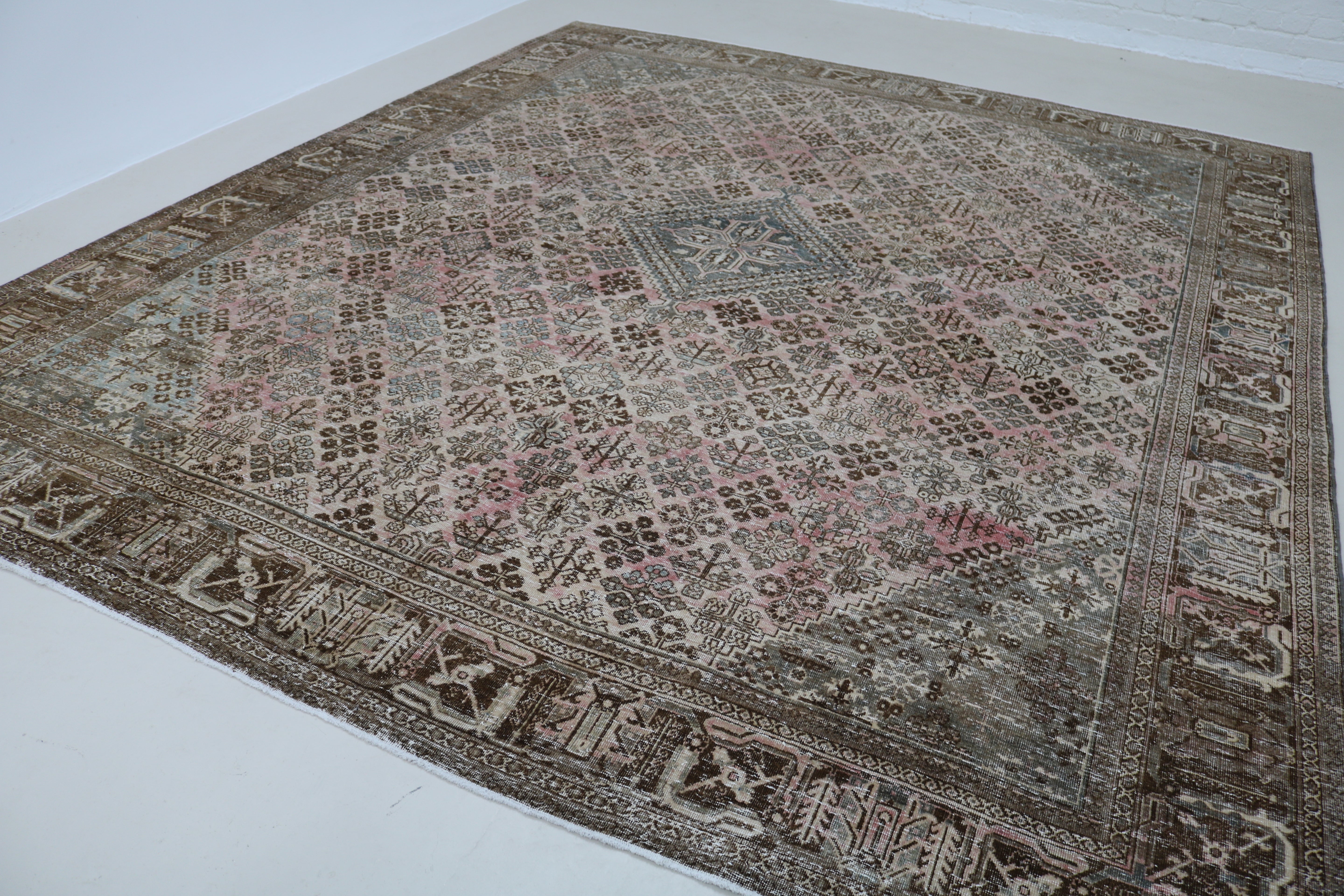 Angled view of Persian Josheqan carpet showing field and borders