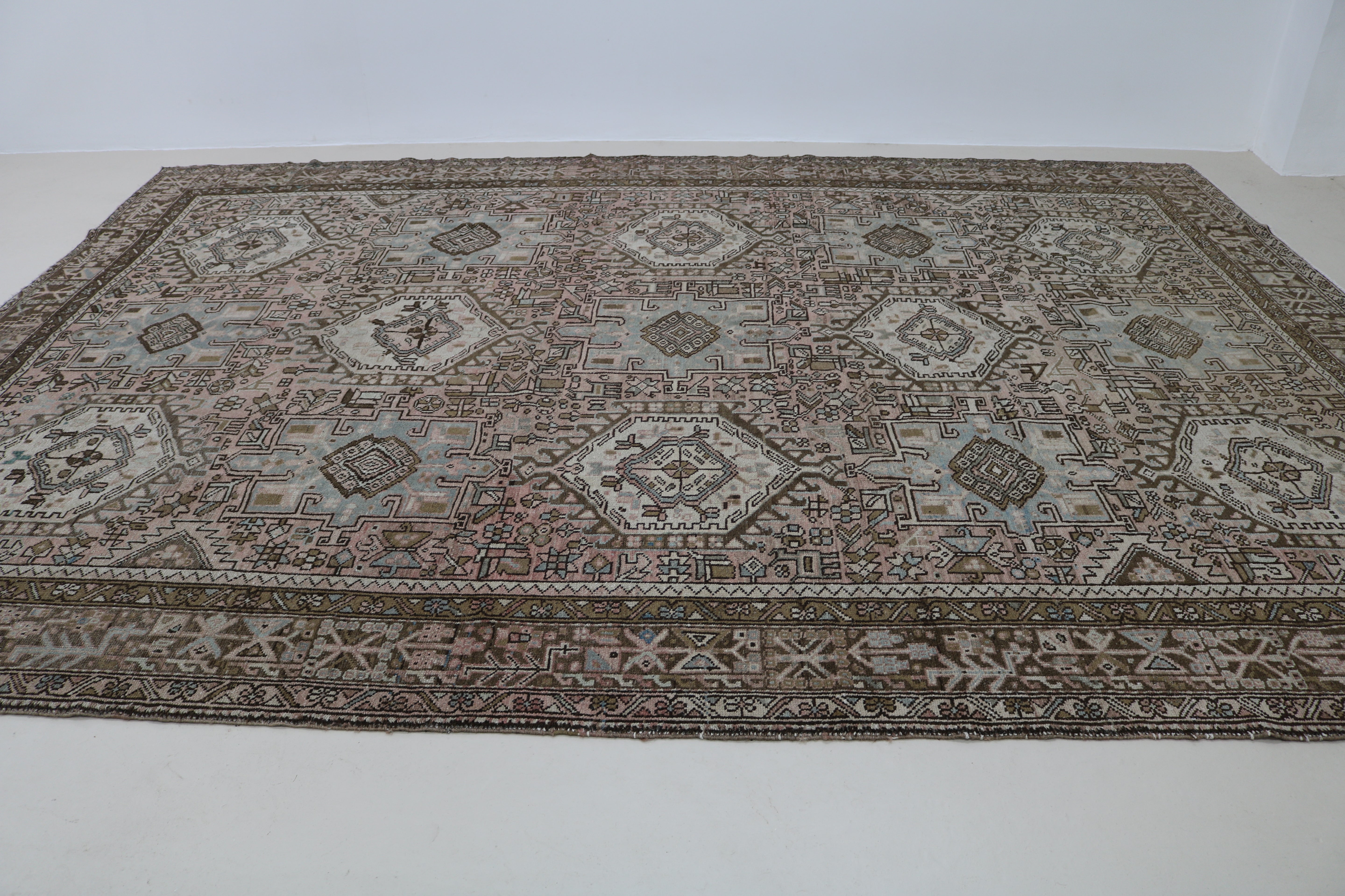Perspective view of antique Persian Heriz–Karaja carpet on floor