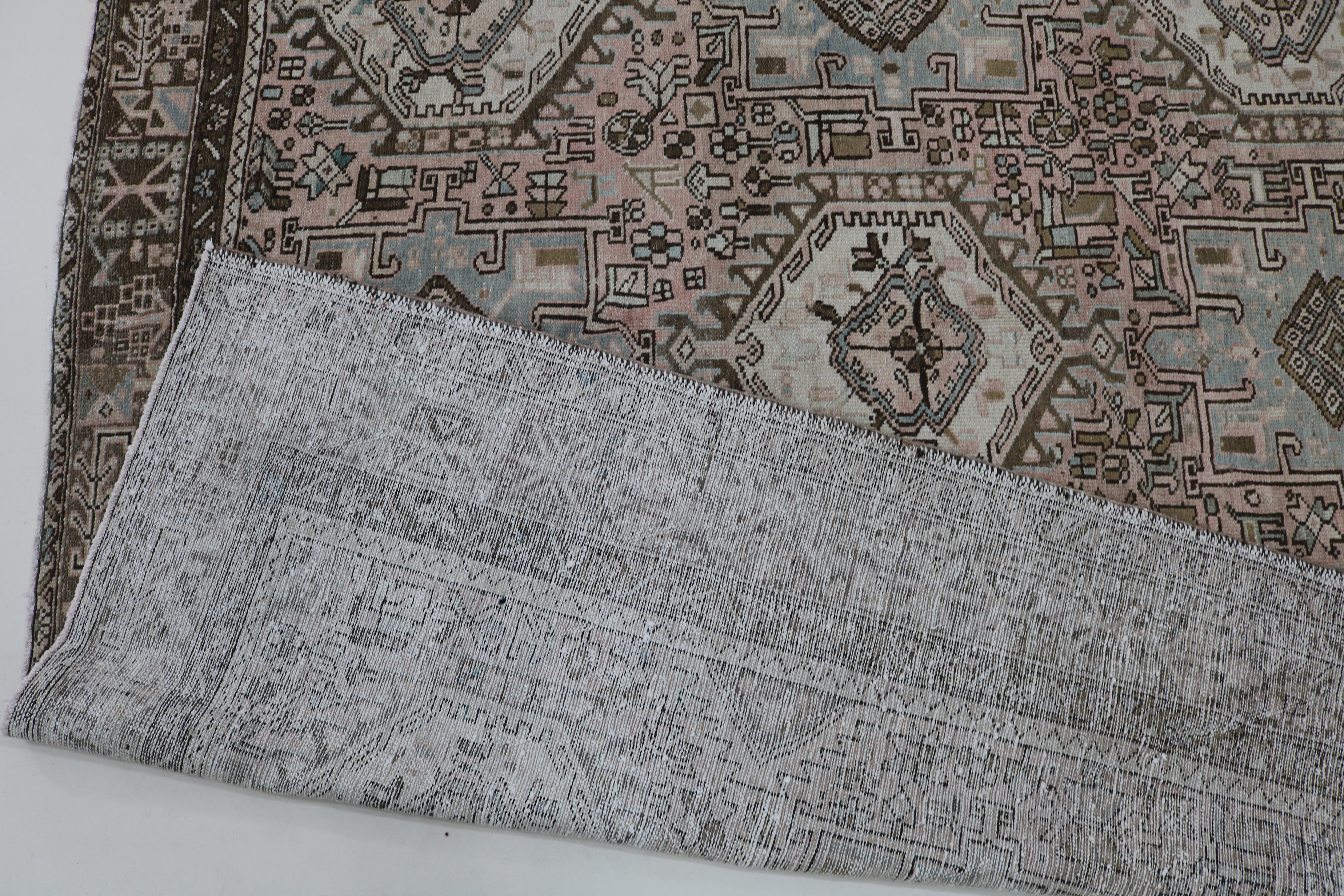 Close-up of hand-knotted wool texture on antique Persian Heriz–Karaja carpet
