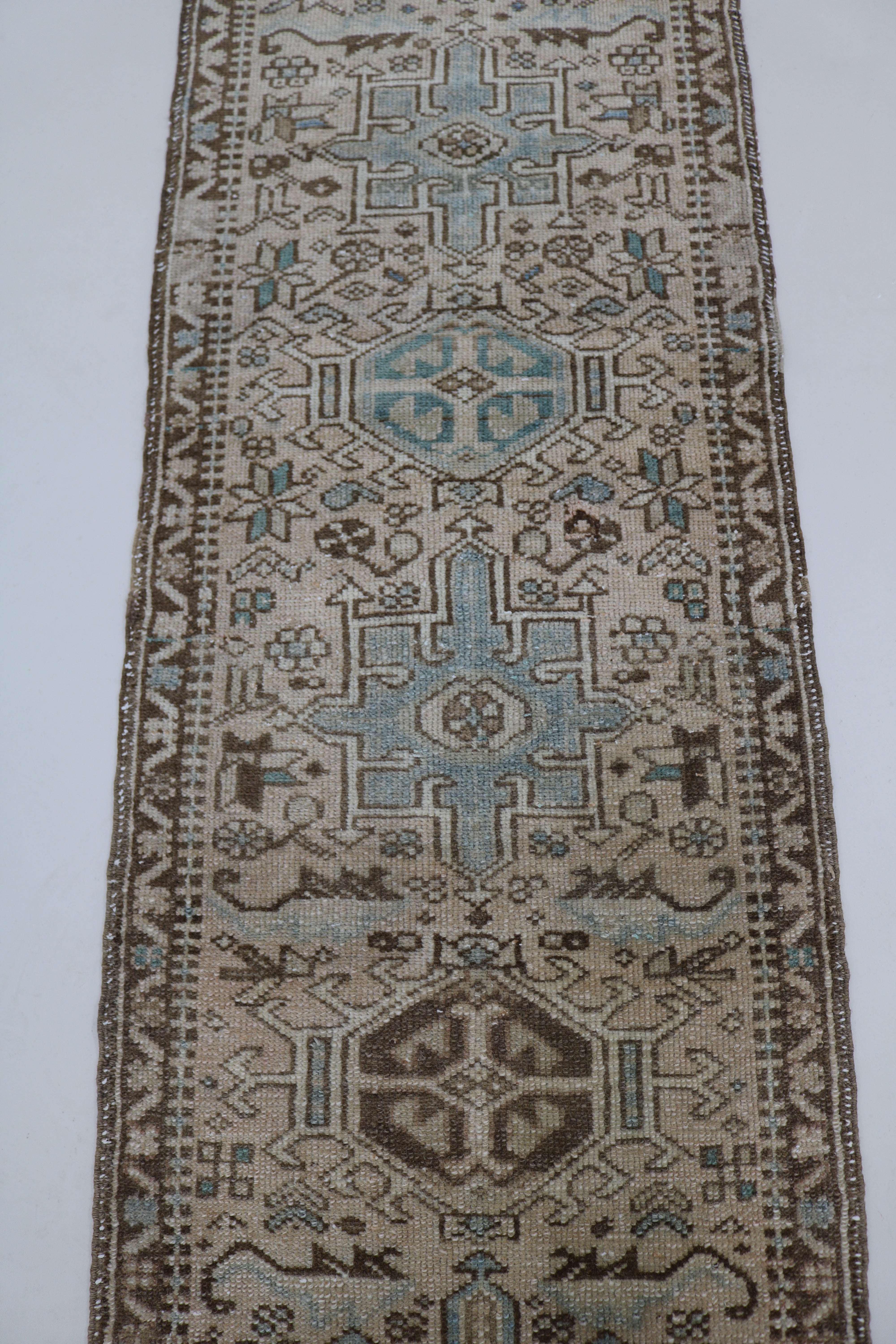 Close-up of hand-knotted wool texture on antique Persian Heriz runner