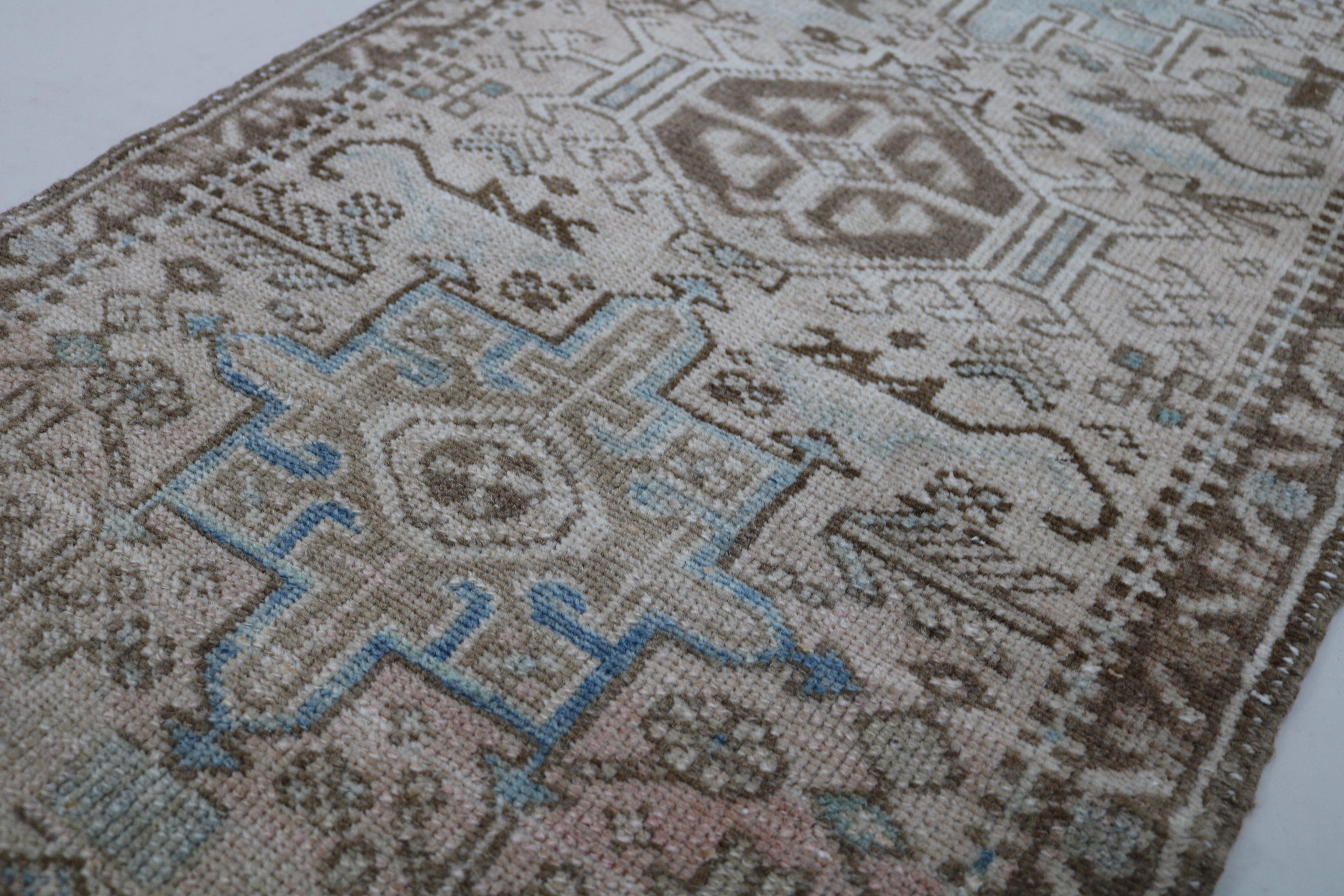 Close-up of hand-knotted wool texture on antique Persian Heriz runner