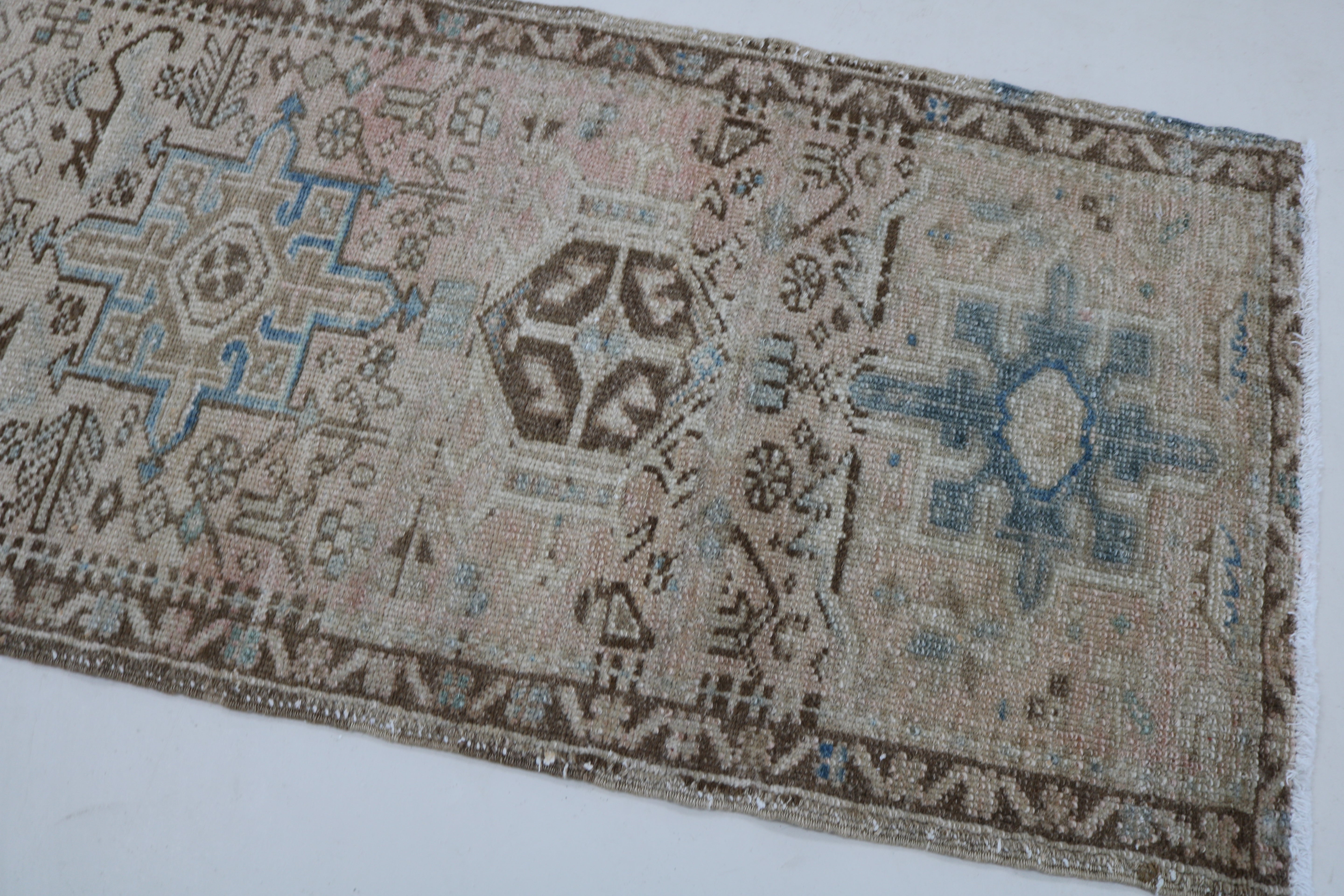 Close-up of hand-knotted wool texture on antique Persian Heriz runner