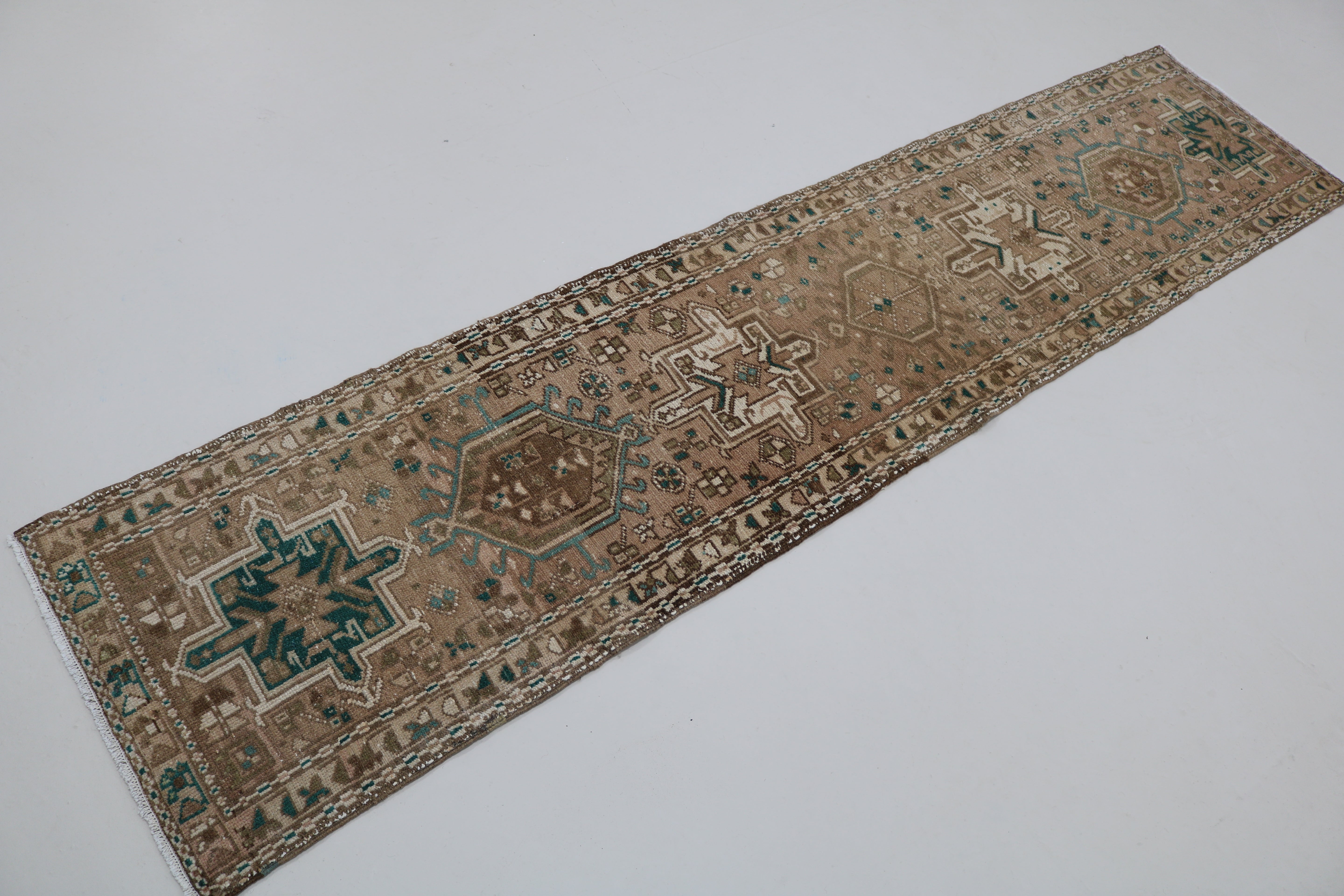 Perspective view of antique Persian Heriz runner on floor