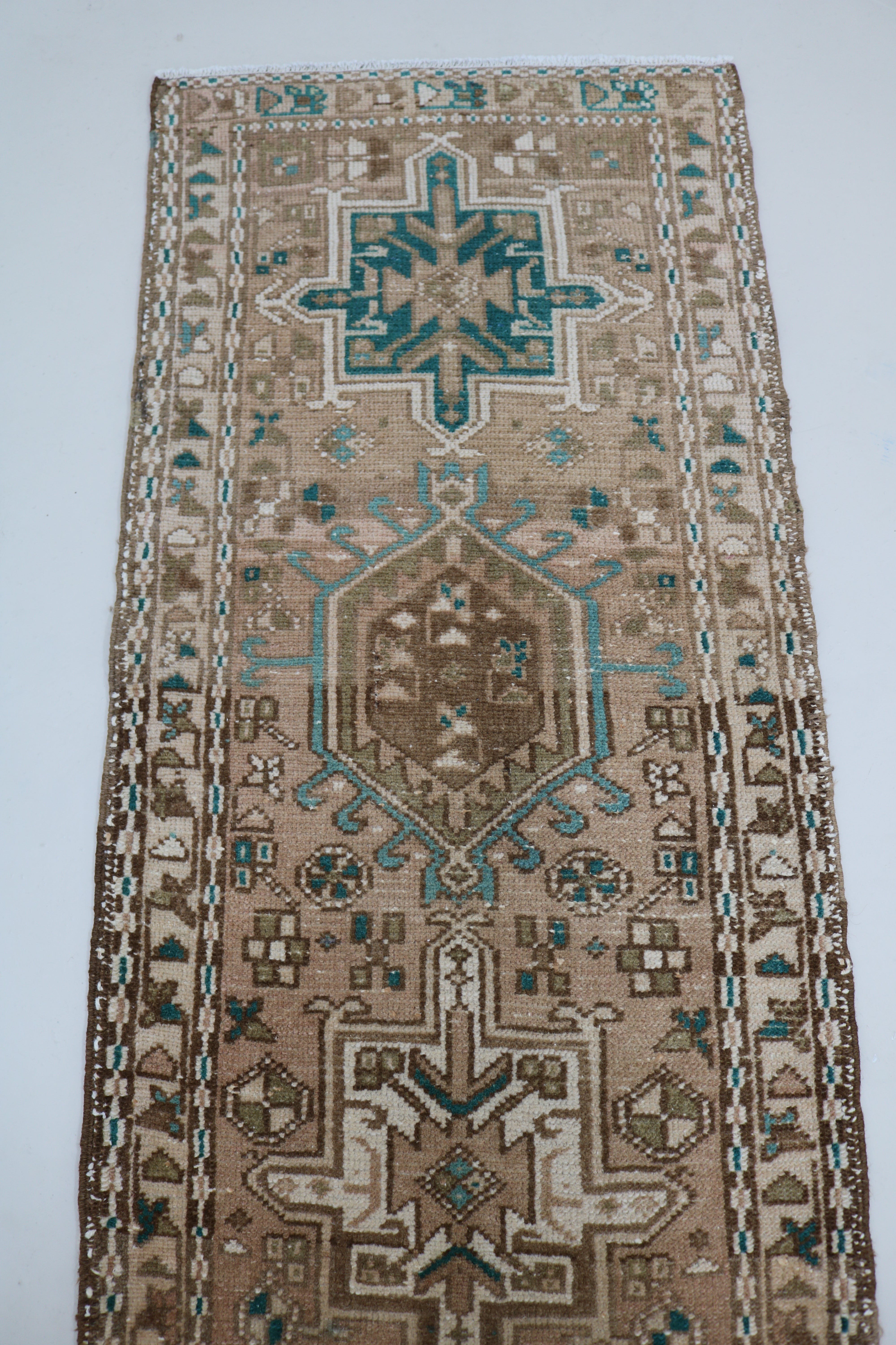 Close-up of hand-knotted wool texture on antique Persian Heriz runner