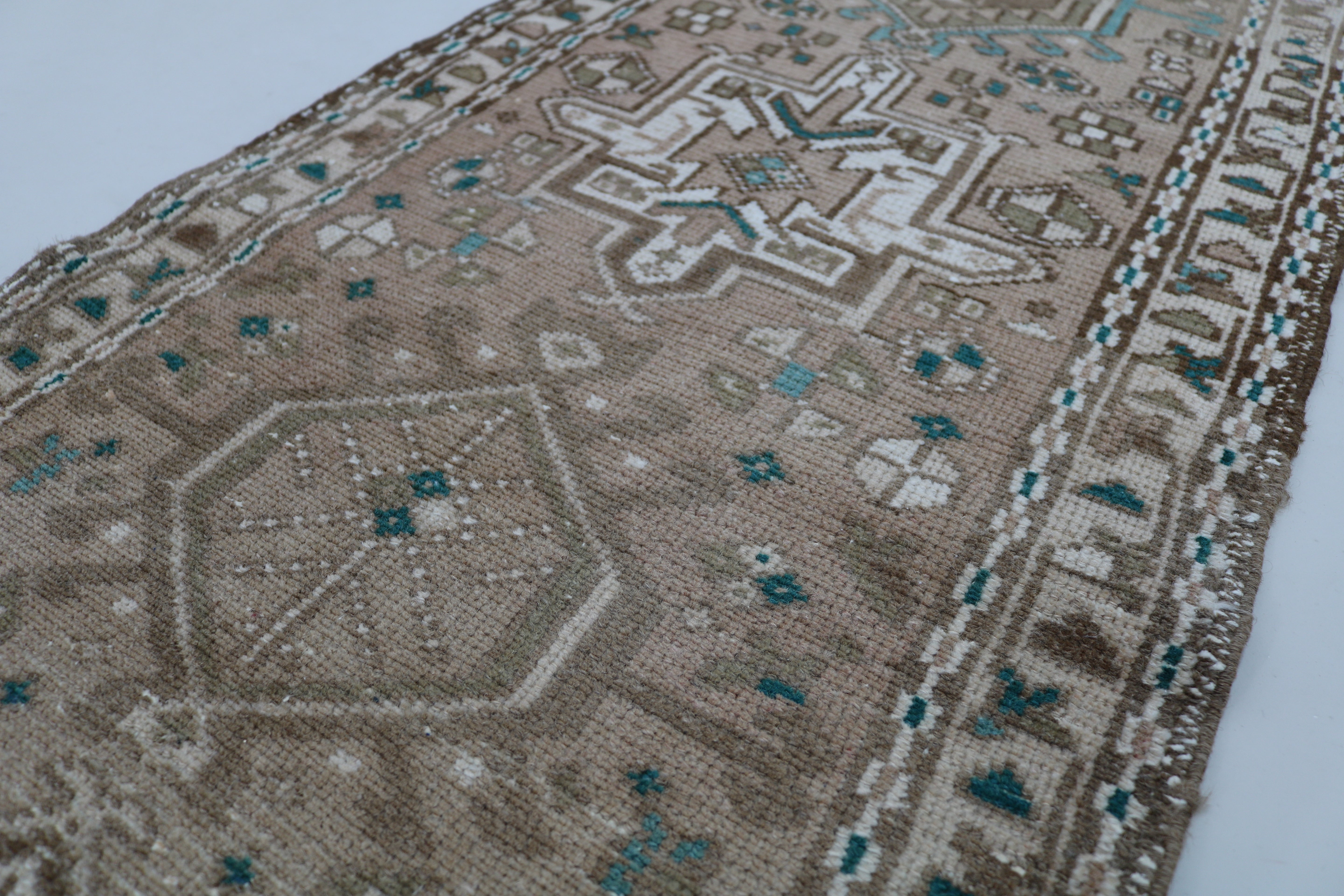 Close-up of hand-knotted wool texture on antique Persian Heriz runner