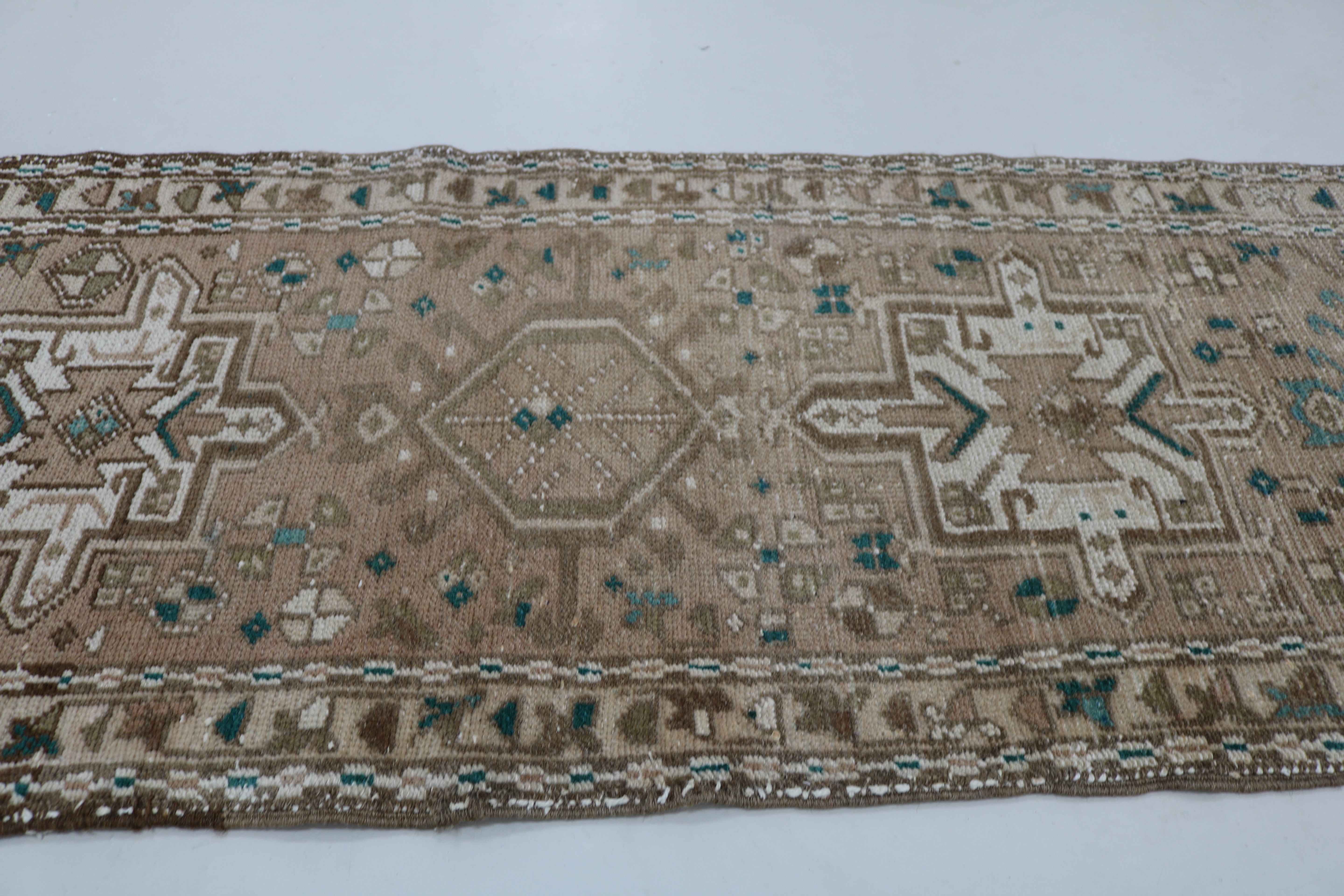 Close-up of hand-knotted wool texture on antique Persian Heriz runner