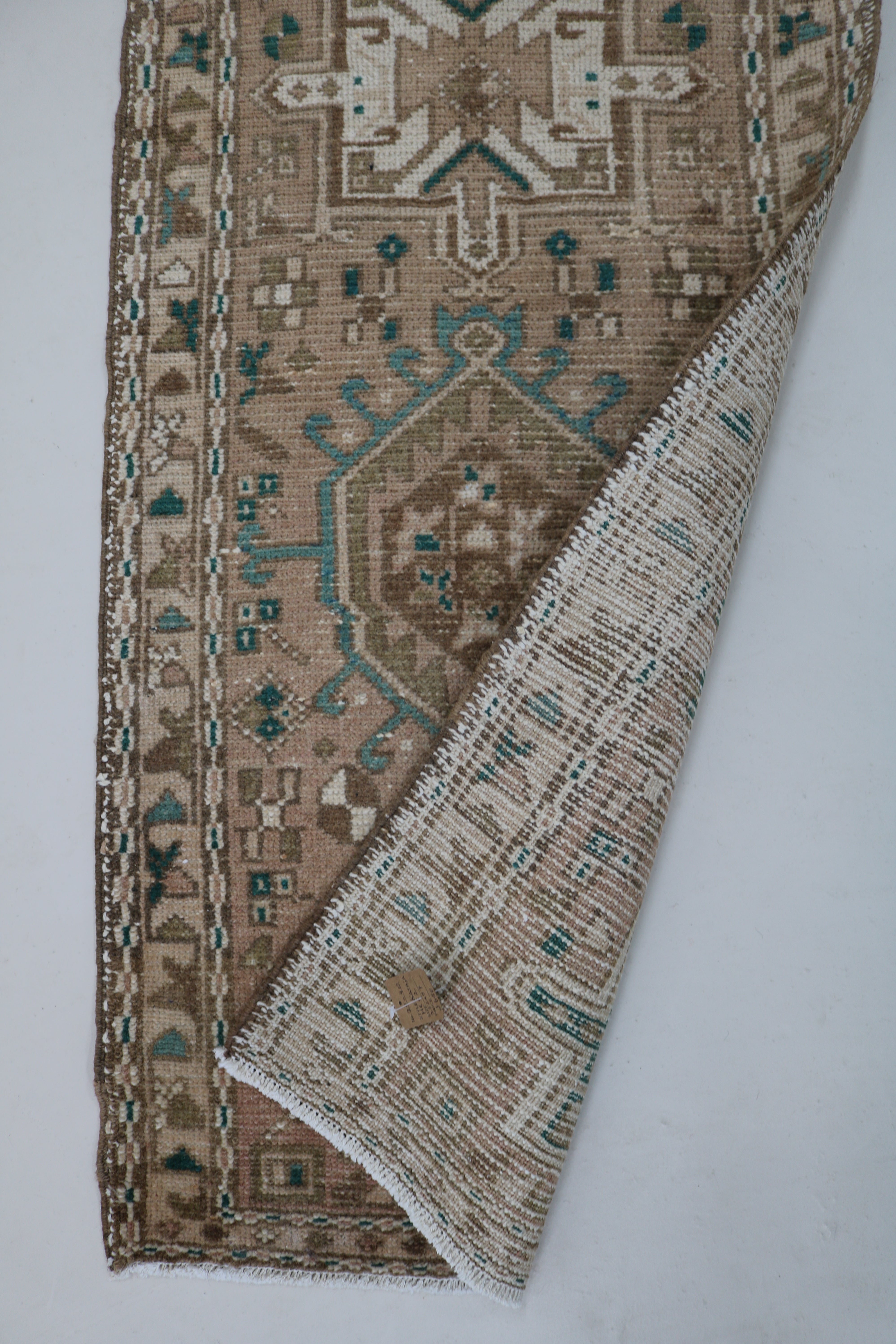 Close-up of hand-knotted wool texture on antique Persian Heriz runner