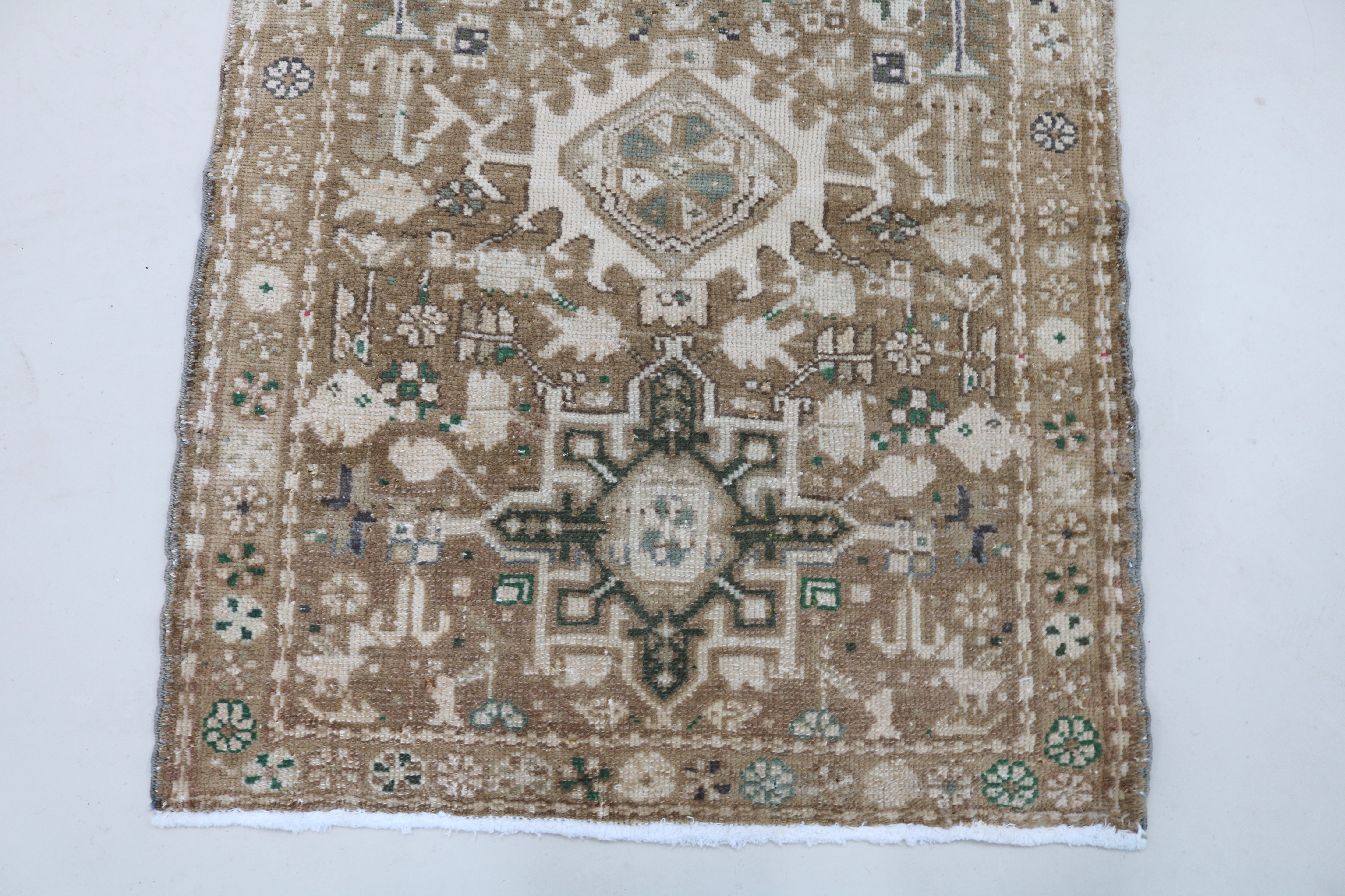 Close-up of hand-knotted wool texture on antique Persian Heriz runner