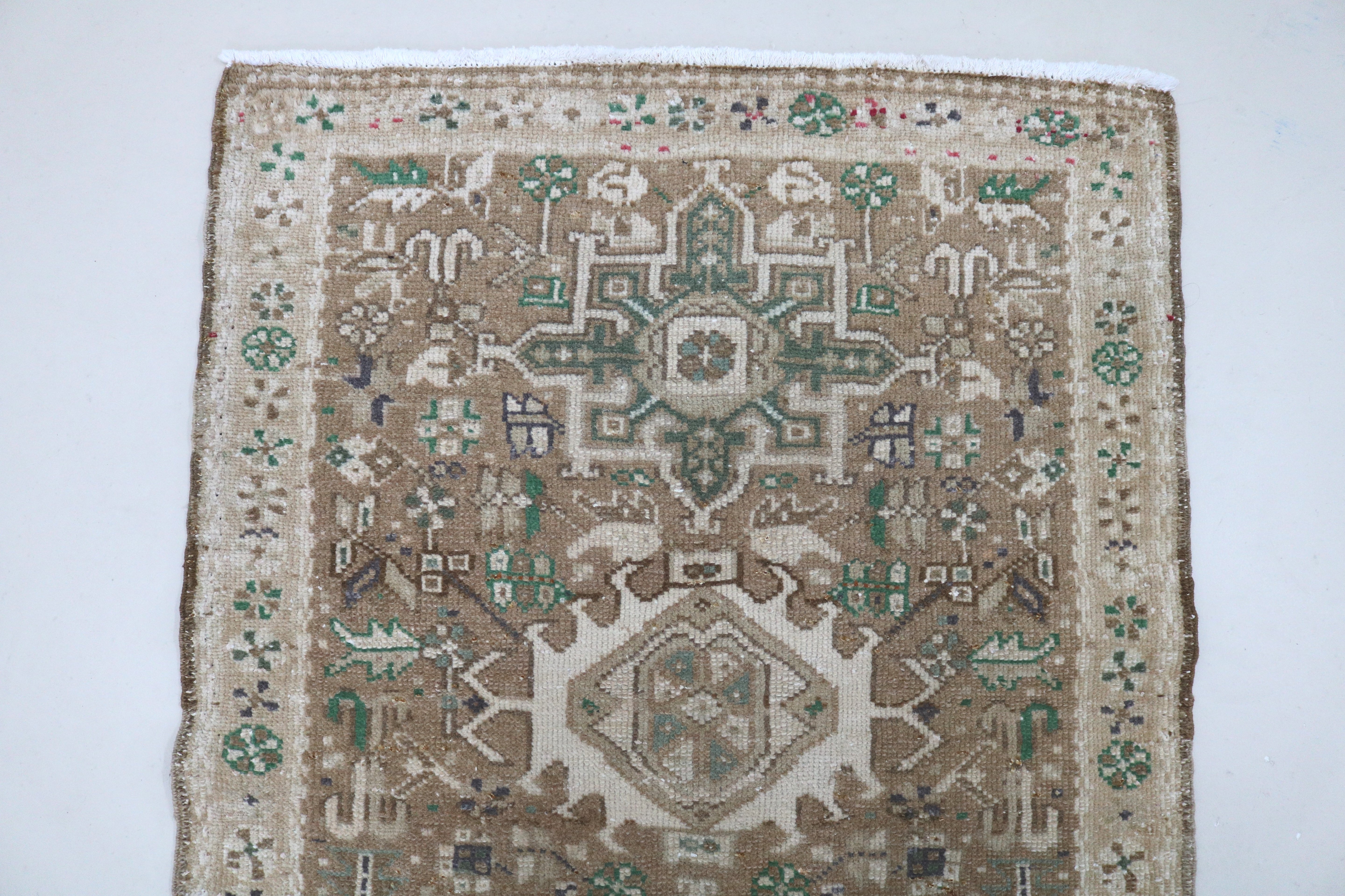 Close-up of hand-knotted wool texture on antique Persian Heriz runner
