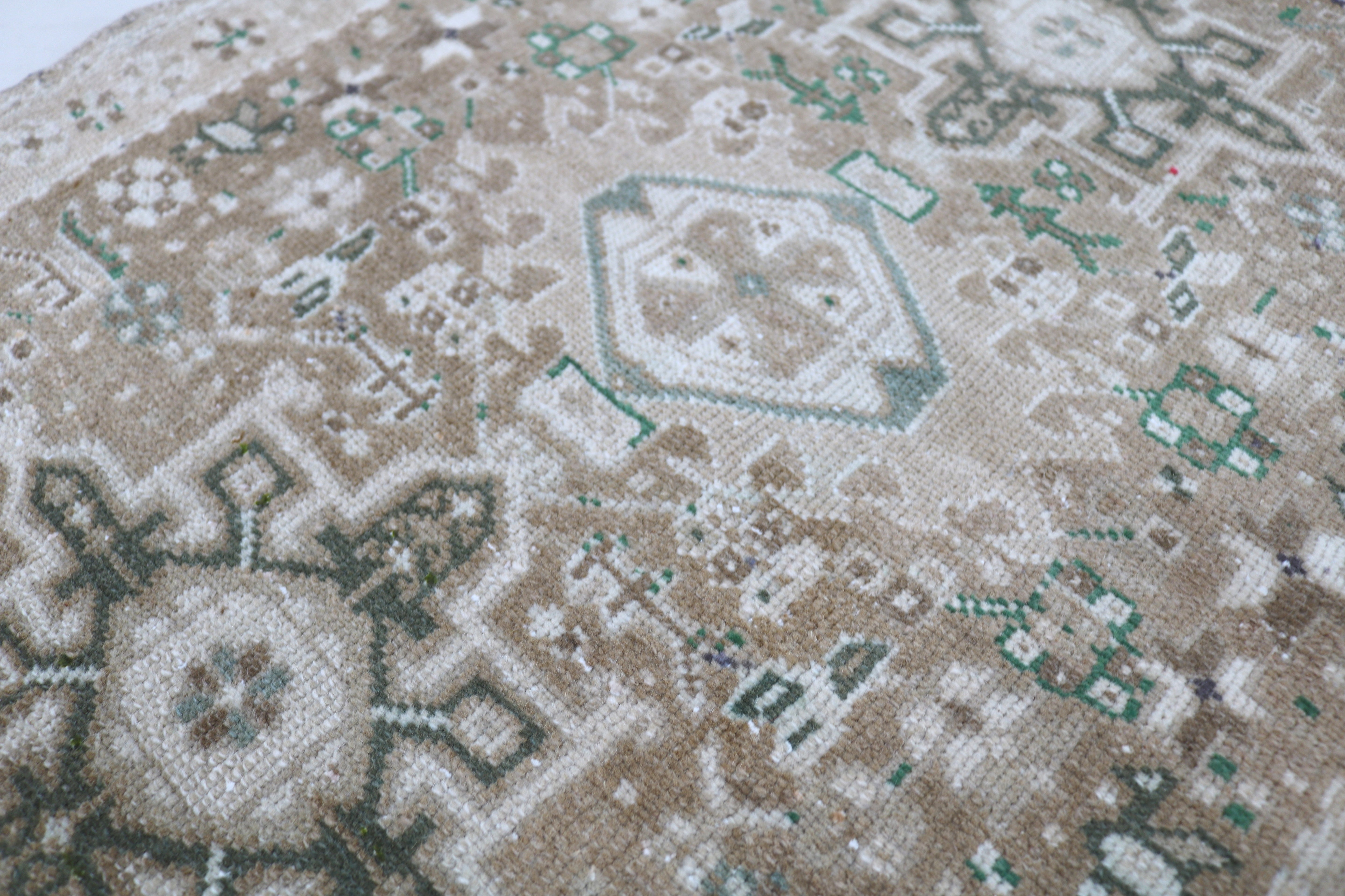 Close-up of hand-knotted wool texture on antique Persian Heriz runner