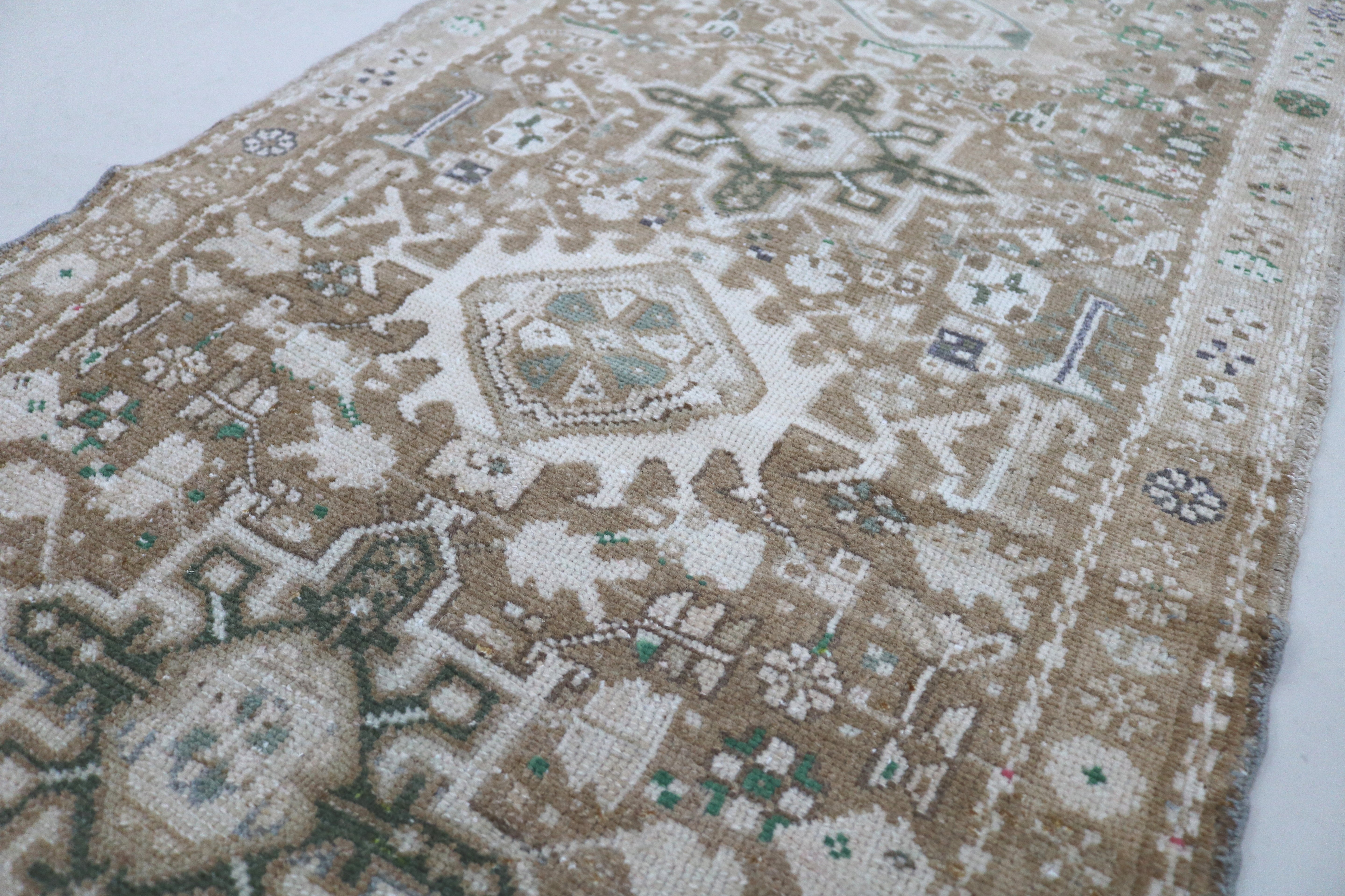 Close-up of hand-knotted wool texture on antique Persian Heriz runner