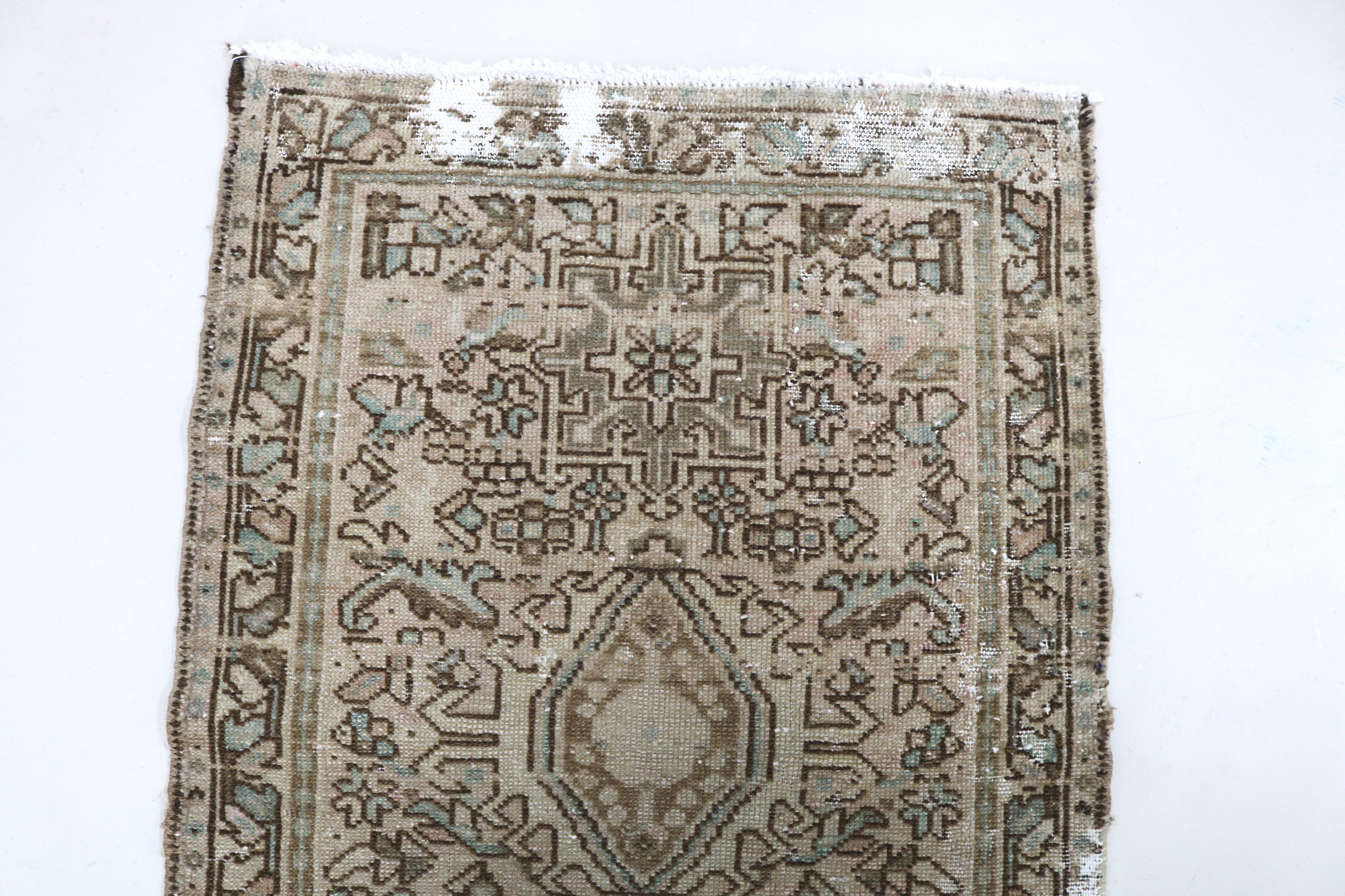 Close-up of hand-knotted wool texture on antique Persian Heriz runner