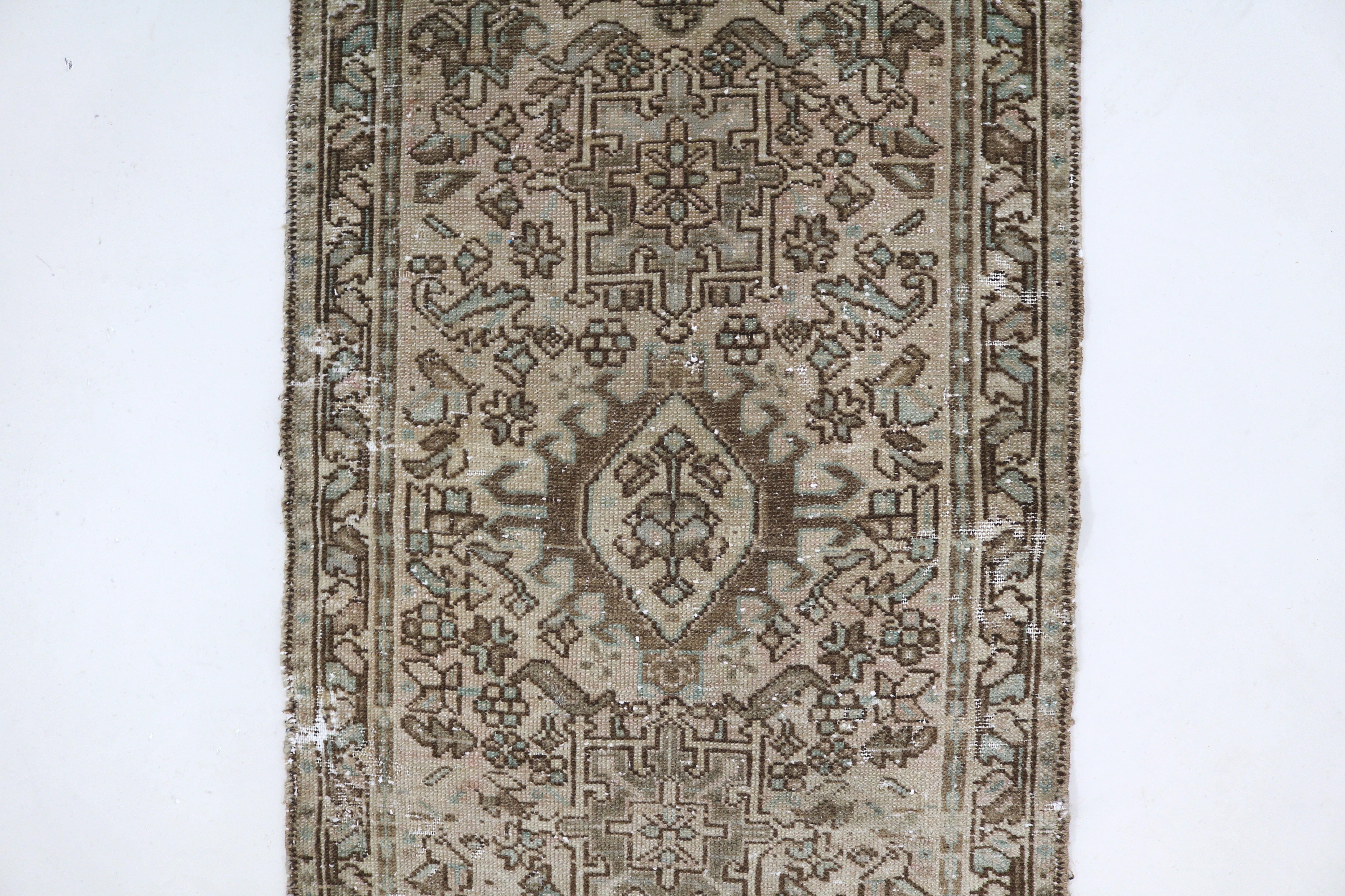 Close-up of hand-knotted wool texture on antique Persian Heriz runner