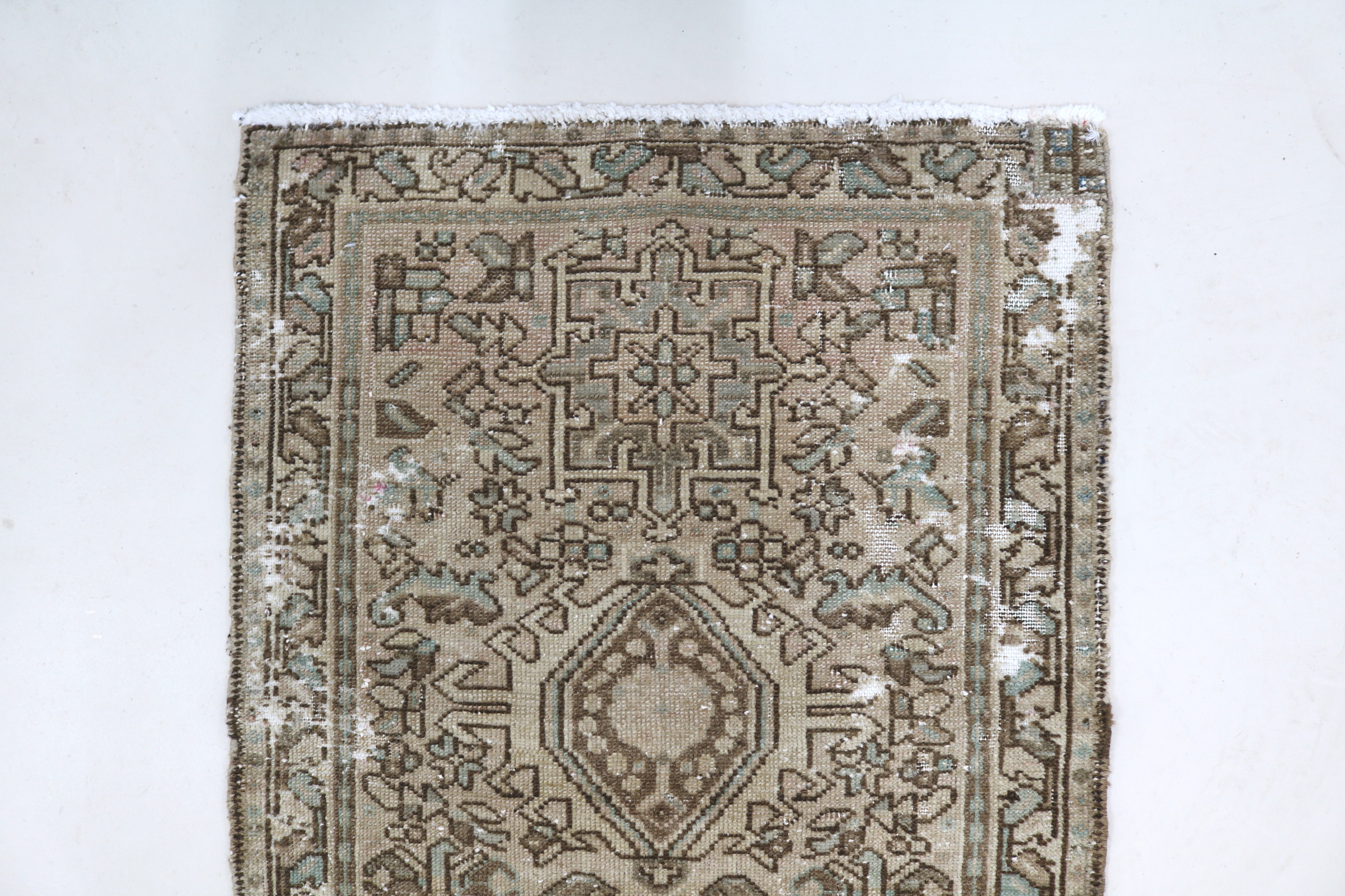 Close-up of hand-knotted wool texture on antique Persian Heriz runner