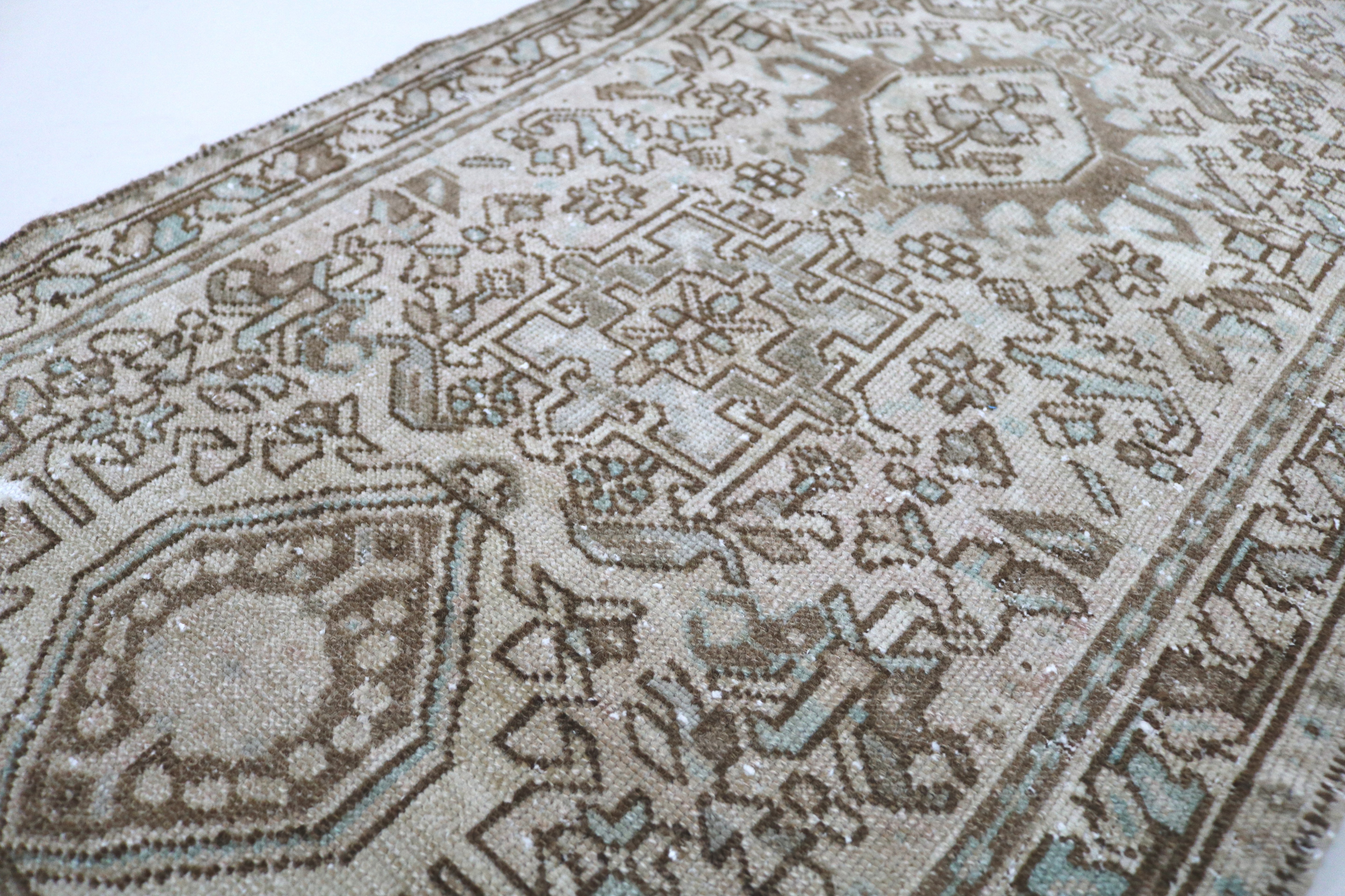 Close-up of hand-knotted wool texture on antique Persian Heriz runner