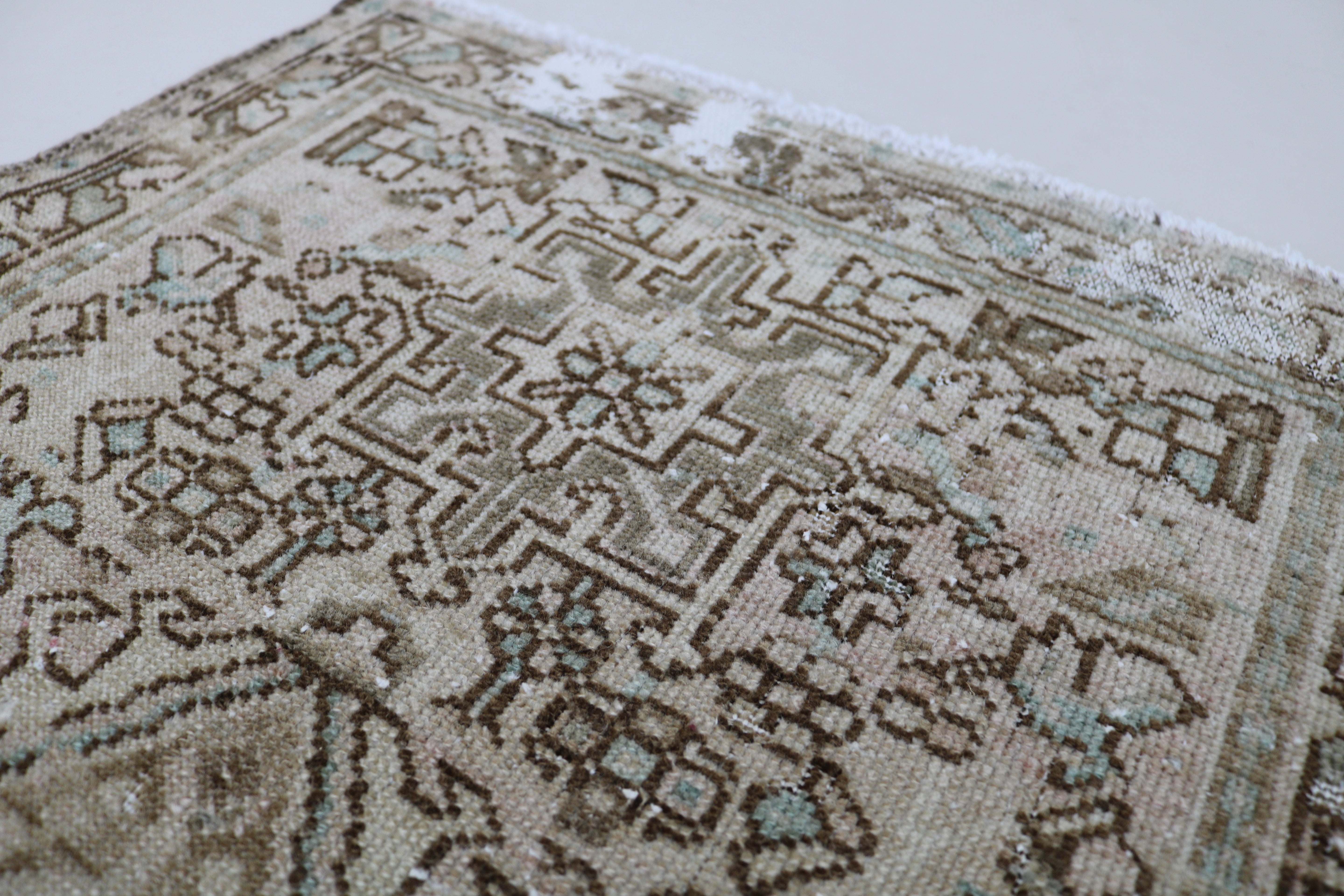 Close-up of hand-knotted wool texture on antique Persian Heriz runner