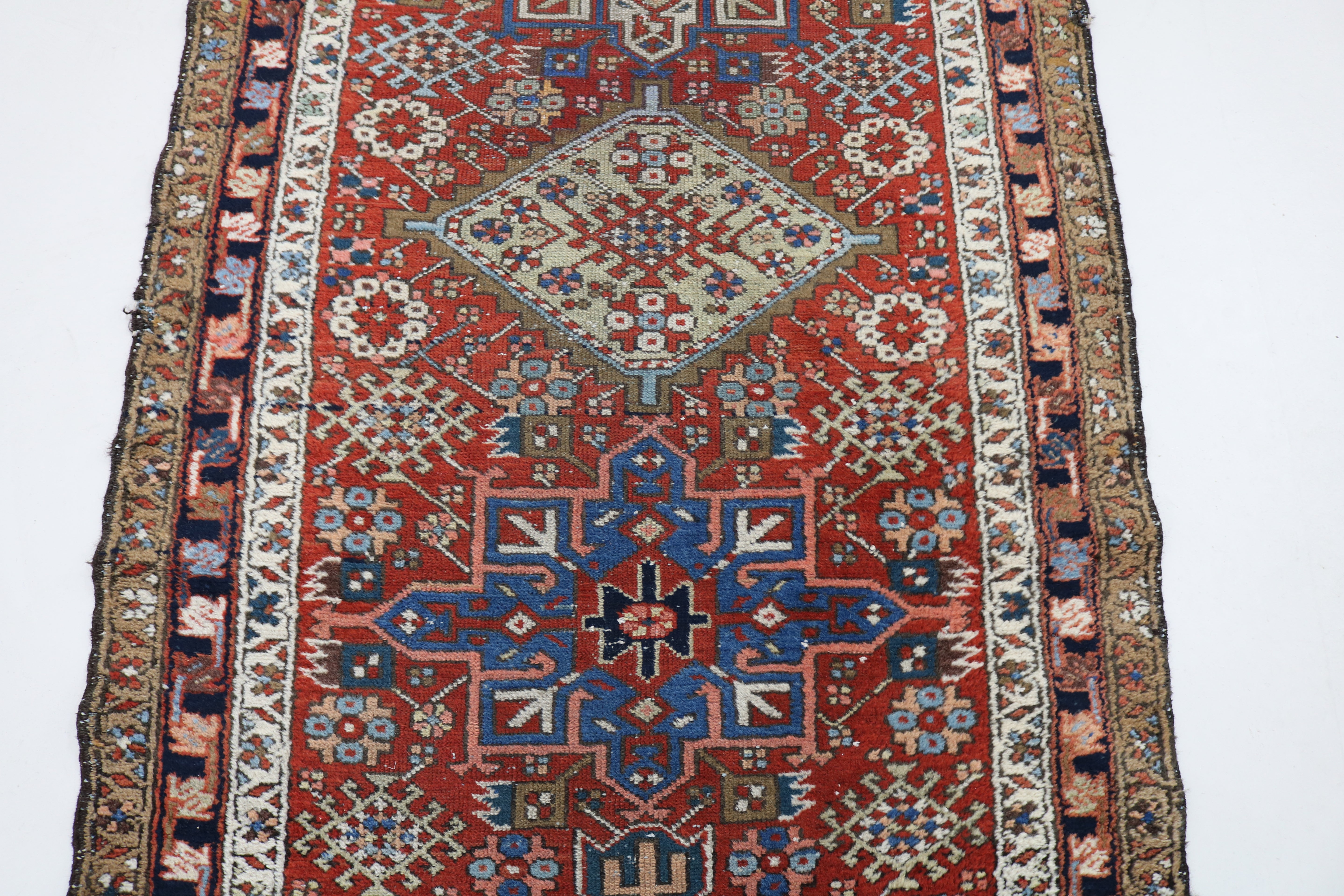 Close-up of hand-knotted wool texture on antique Persian Karaja runner