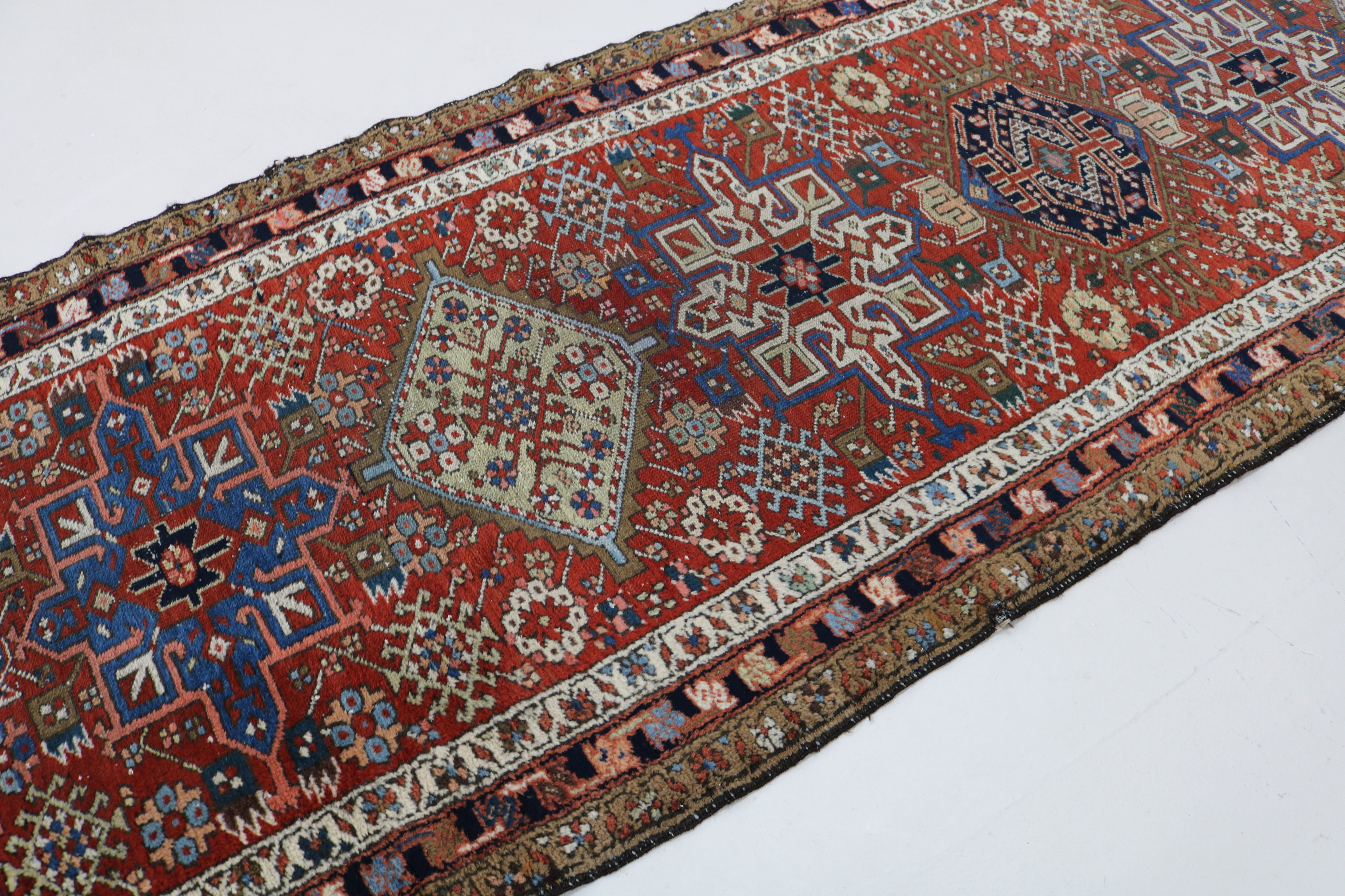 Close-up of hand-knotted wool texture on antique Persian Karaja runner