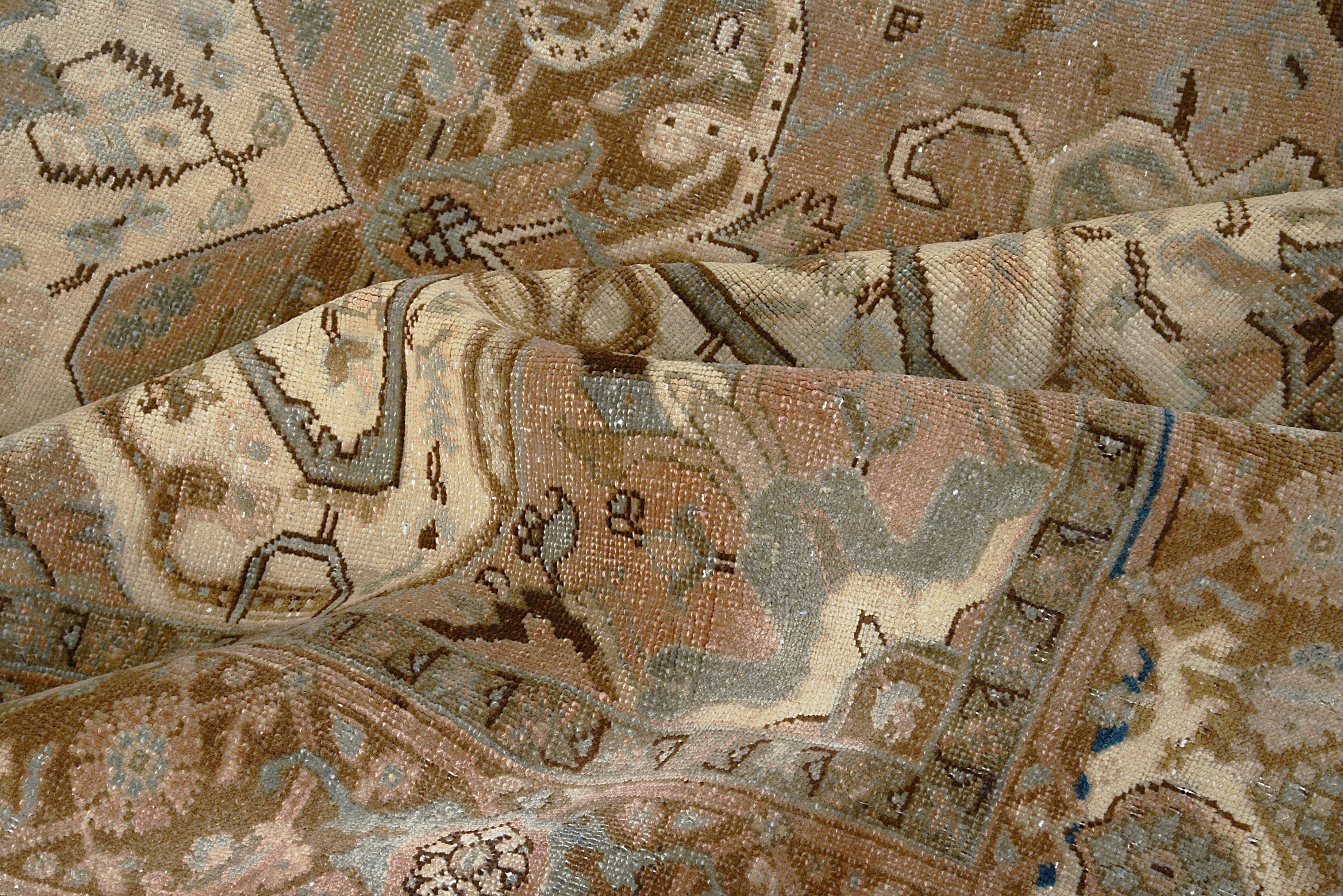 Close-up details of vintage Persian Heriz carpet showing wool texture, motifs, and natural patina