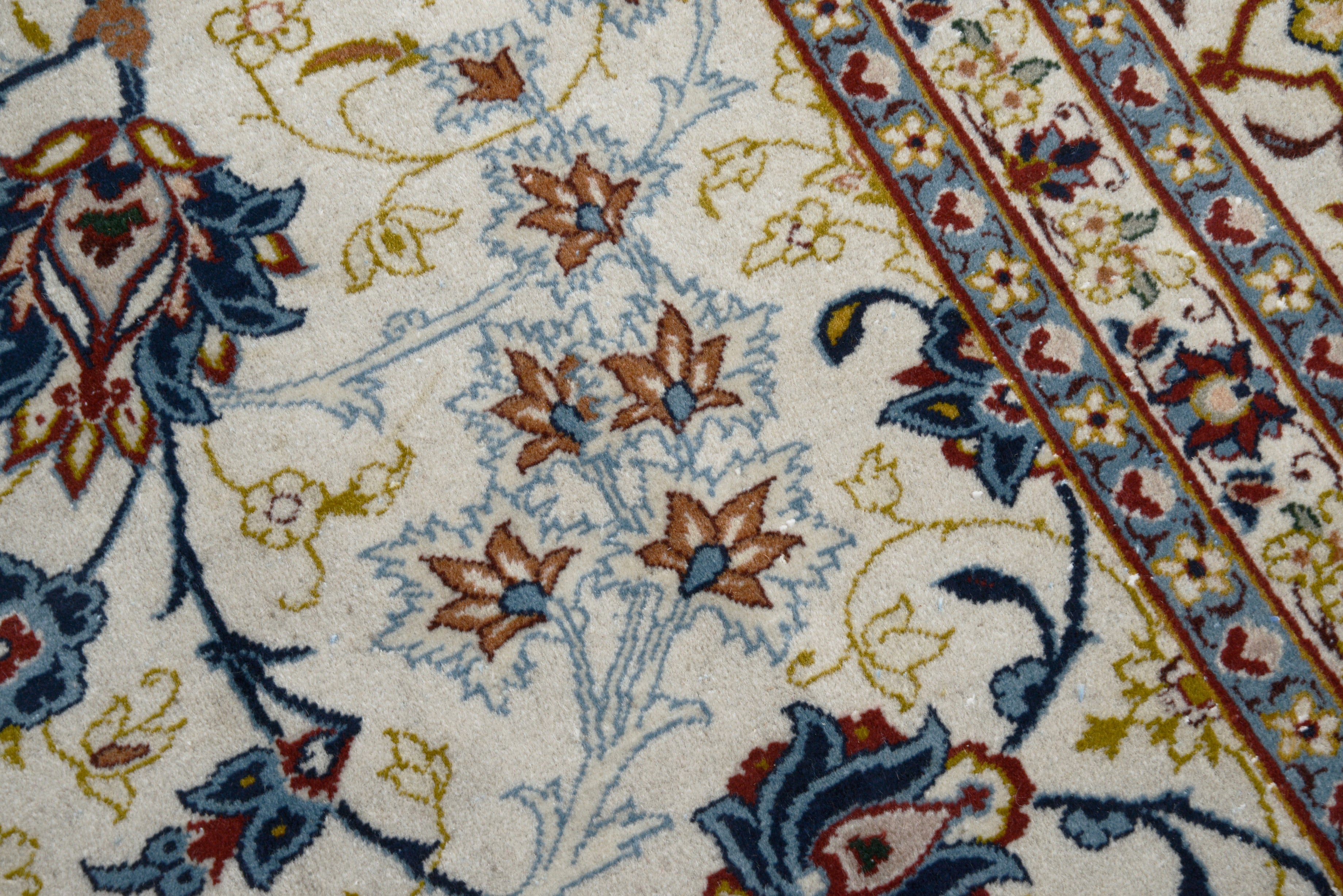 Close-up details of fine antique Persian Kashan rug showing silk warp fringes, wool texture, and aged patina