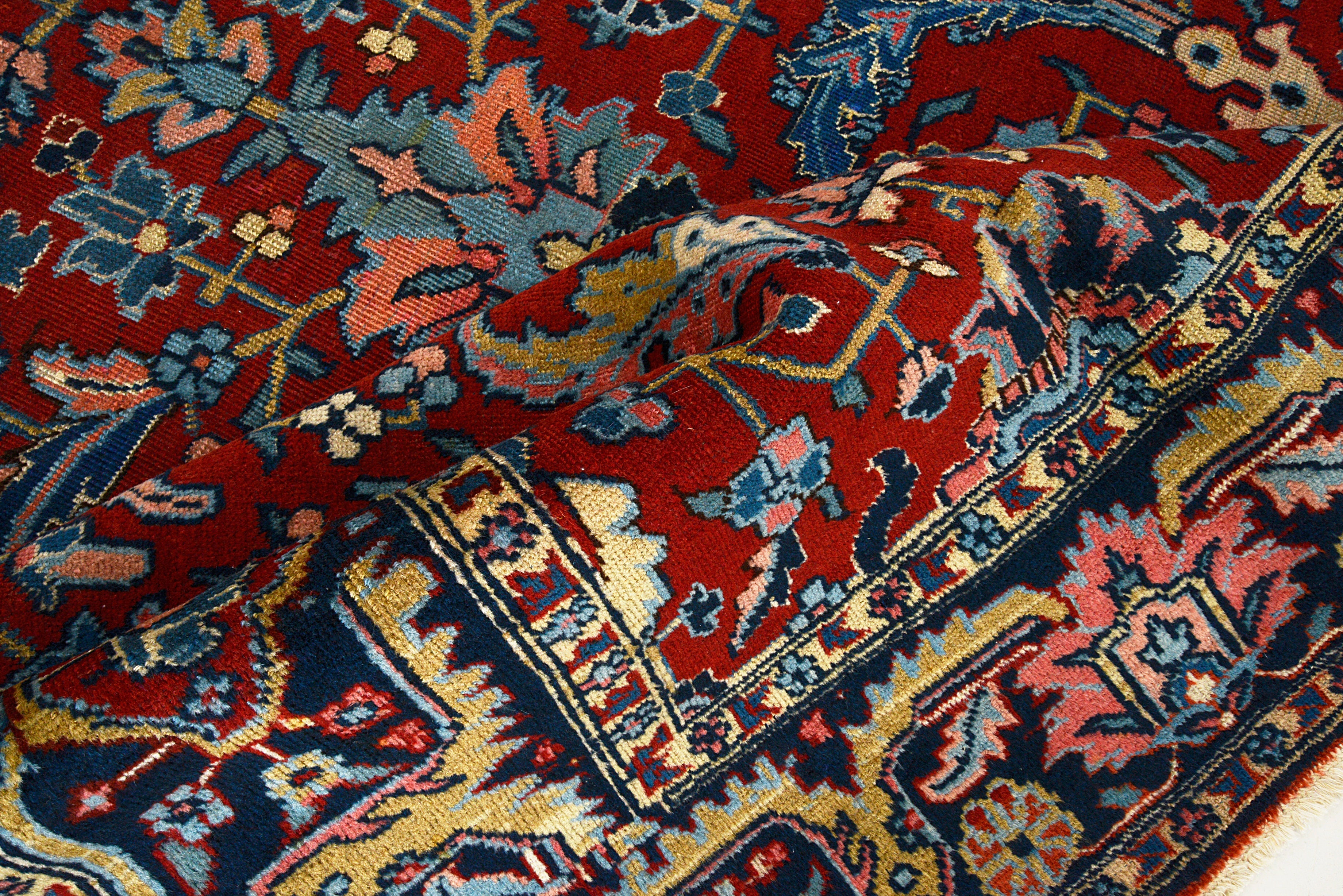 Close-up details of antique Persian Heriz carpet showing wool texture, motifs, and natural patina