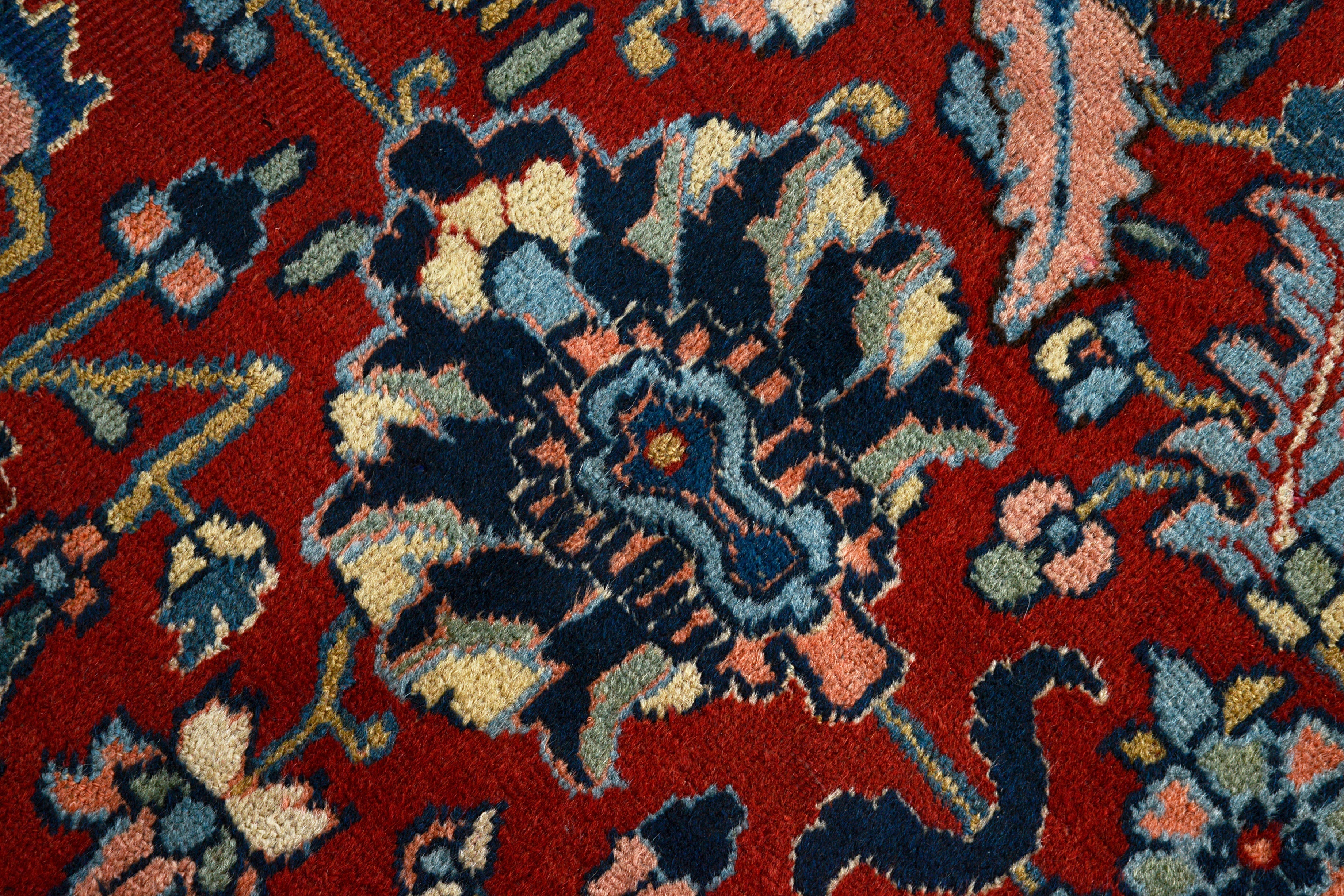 Close-up details of antique Persian Heriz carpet showing wool texture, motifs, and natural patina