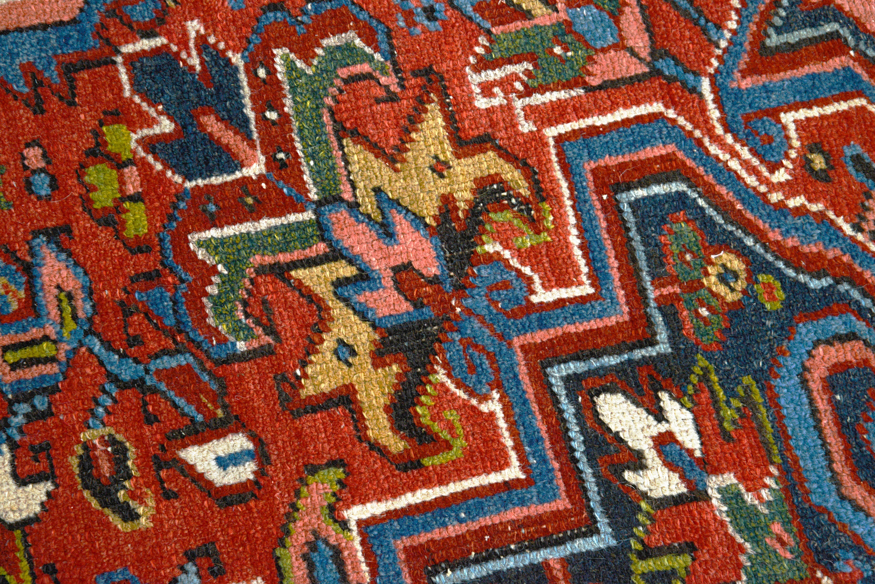 Close-up details of antique Persian Heriz carpet showing wool texture, motifs, and aged patina