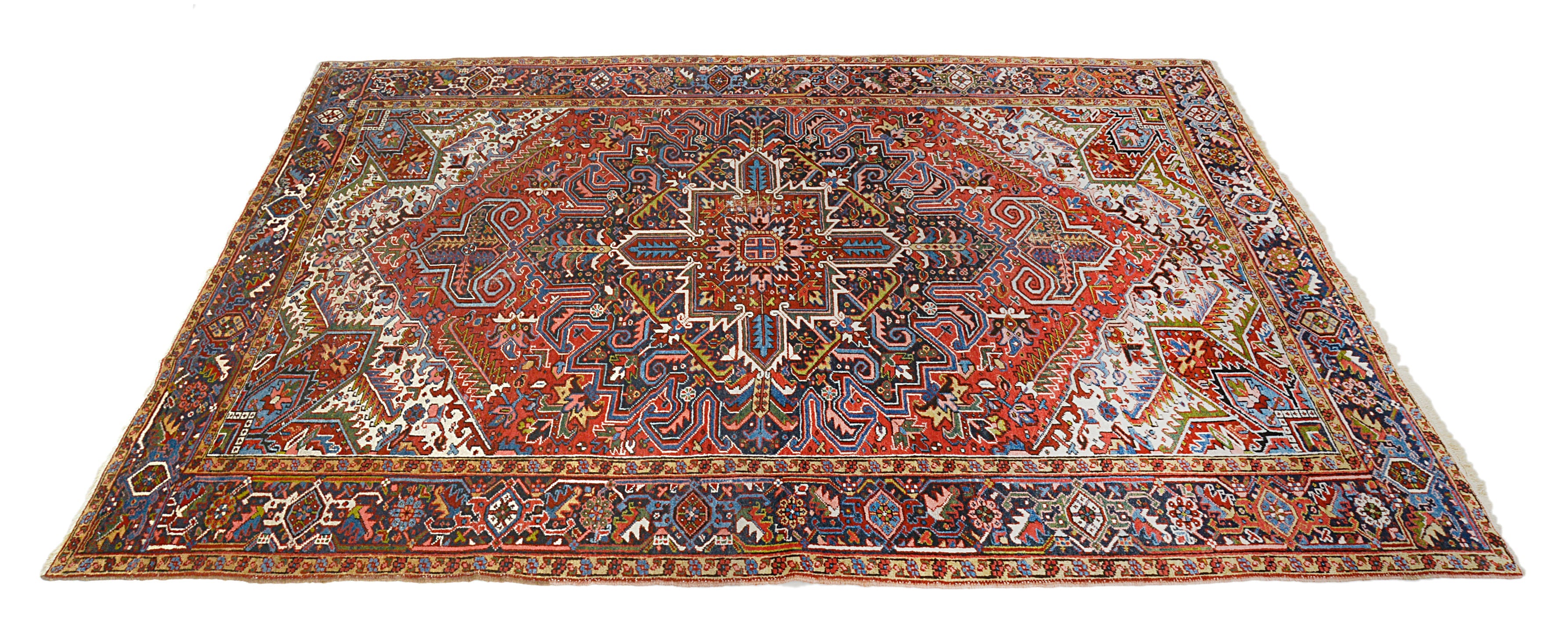 Hand-knotted antique Persian Heriz carpet with central medallion and vibrant geometric design