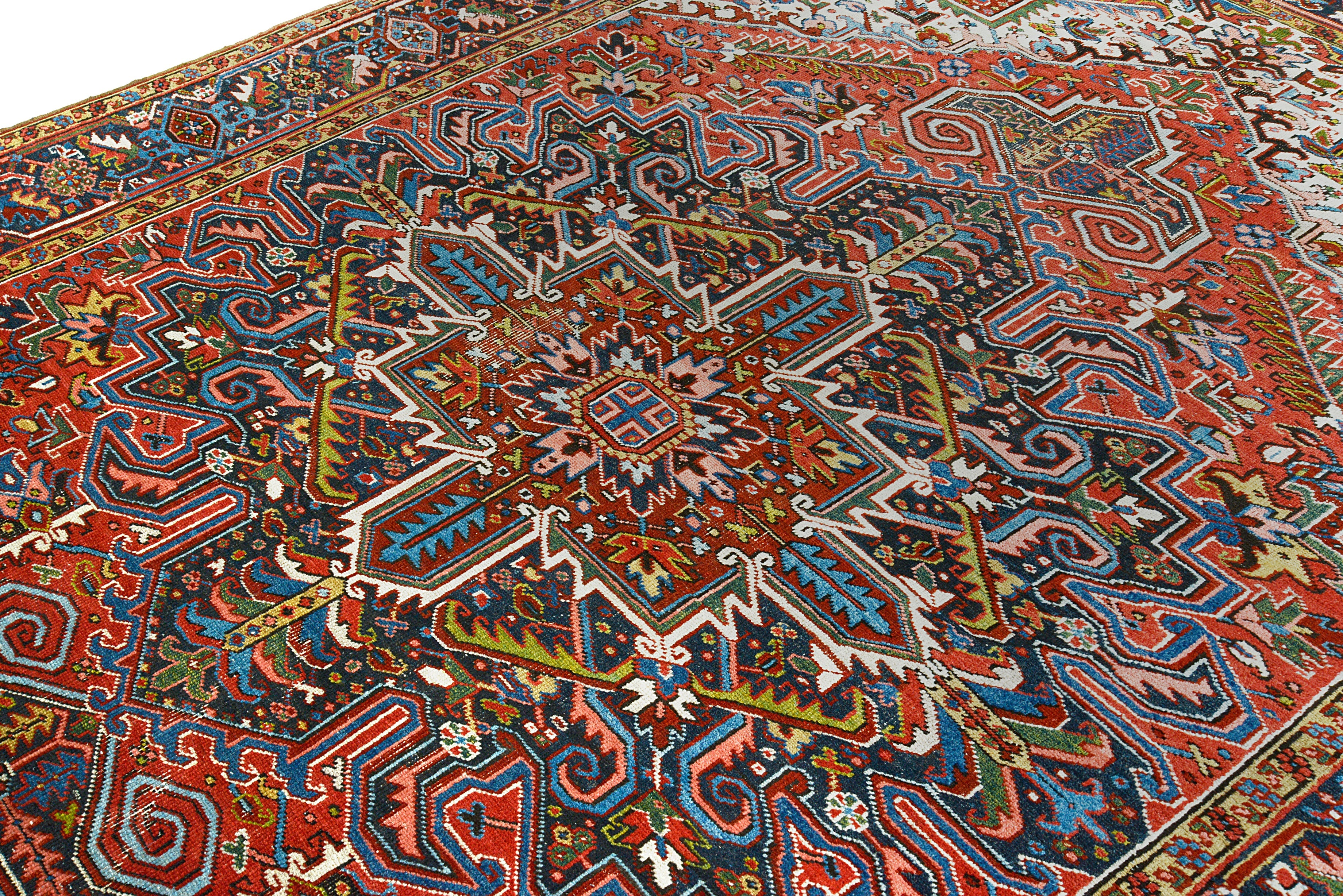 Close-up details of antique Persian Heriz carpet showing wool texture, motifs, and aged patina