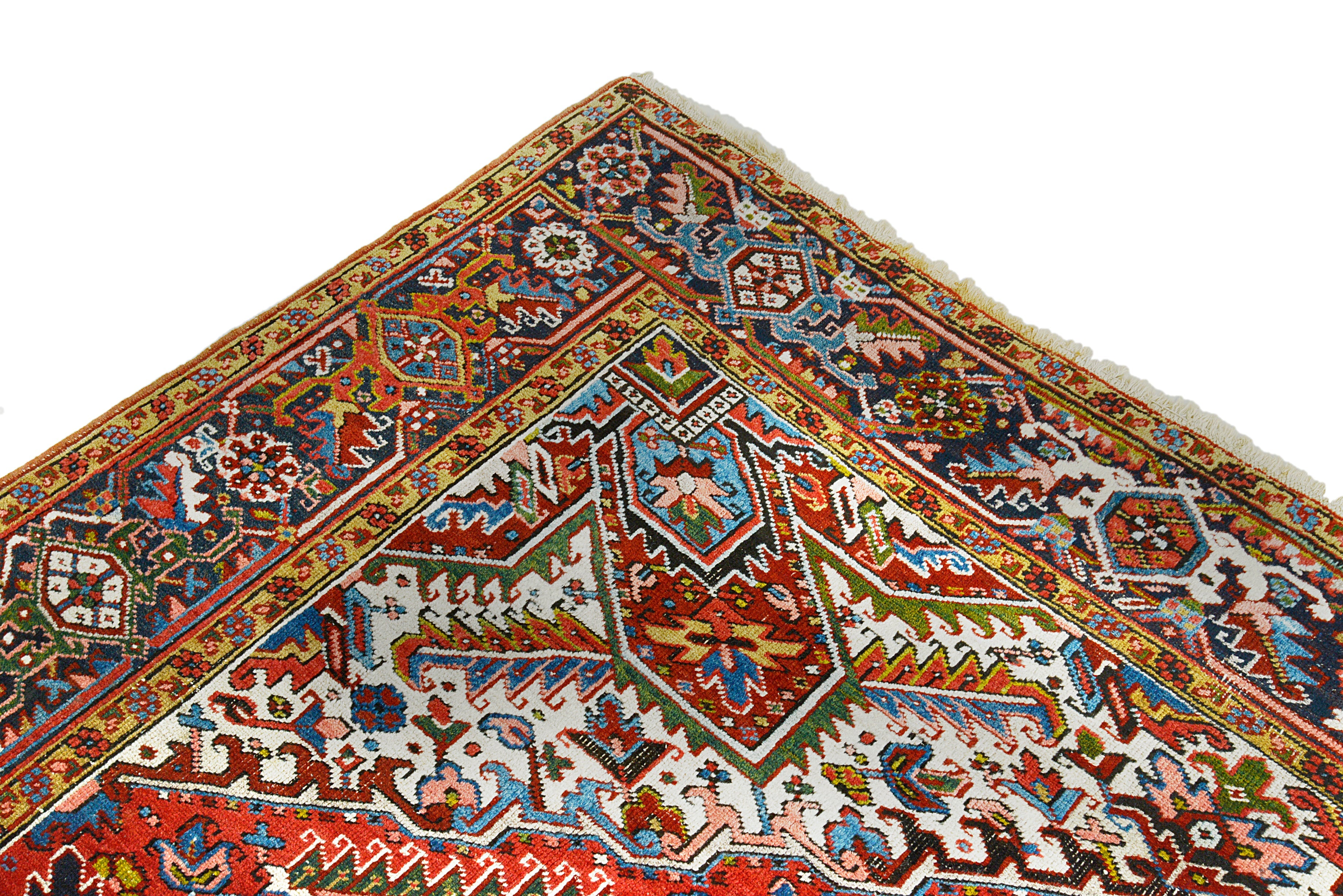 Close-up details of antique Persian Heriz carpet showing wool texture, motifs, and aged patina
