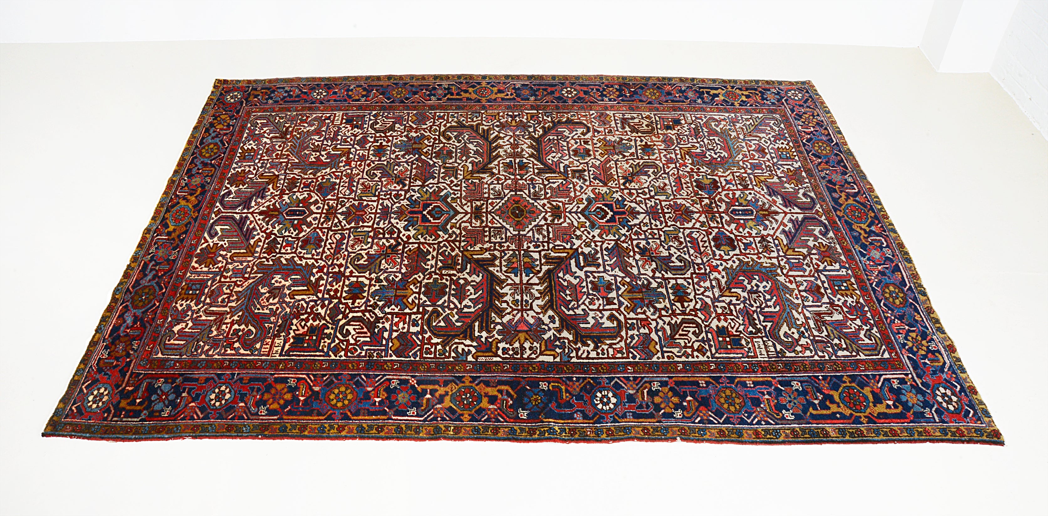 Hand-knotted vintage Heriz carpet with bold all-over geometric pattern and rich red tones