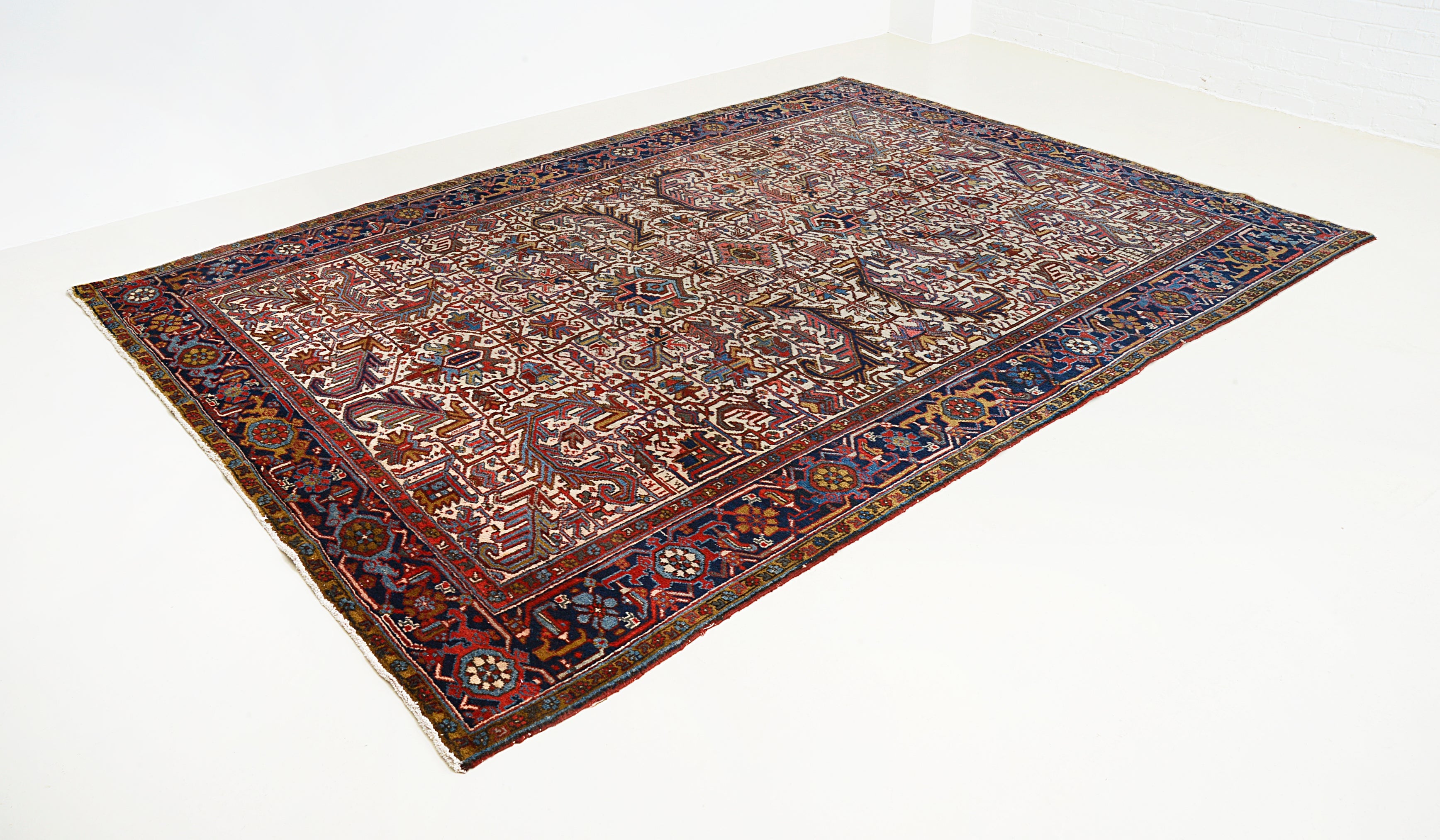 Large vintage Heriz carpet featuring traditional design and contrasting blue border