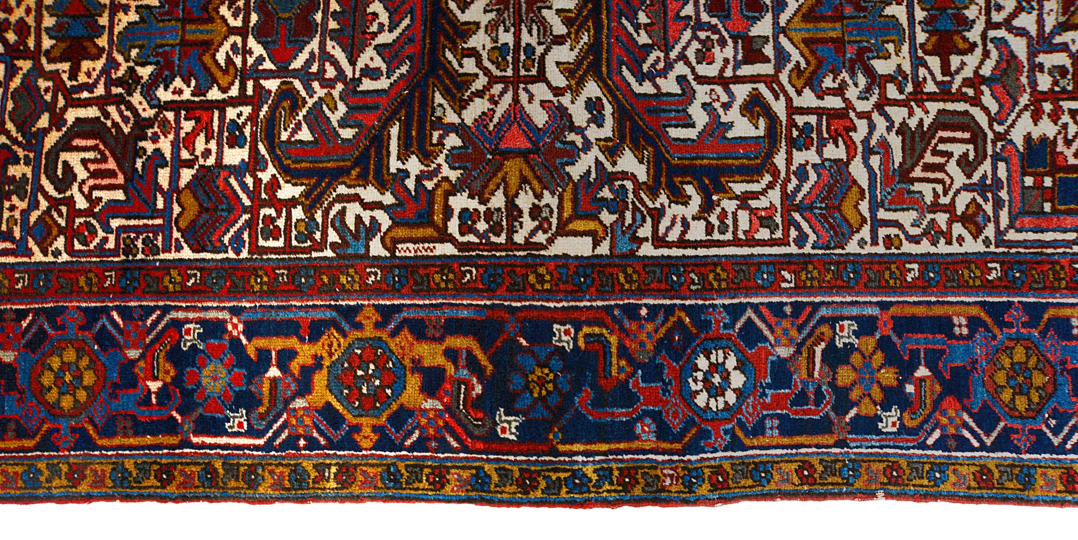 Close-up details of vintage Heriz carpet showing wool texture, motifs, and natural patina
