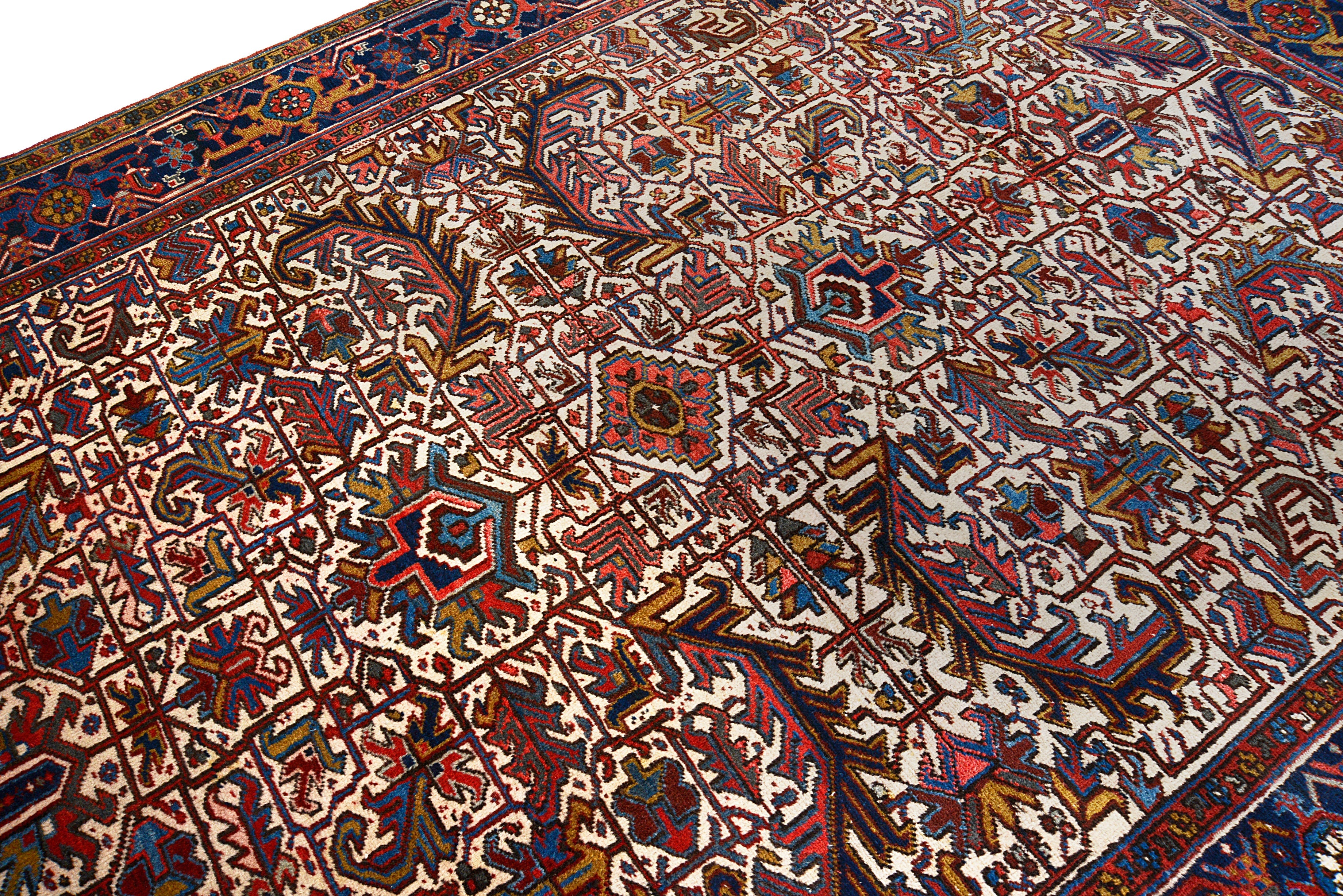 Close-up details of vintage Heriz carpet showing wool texture, motifs, and natural patina
