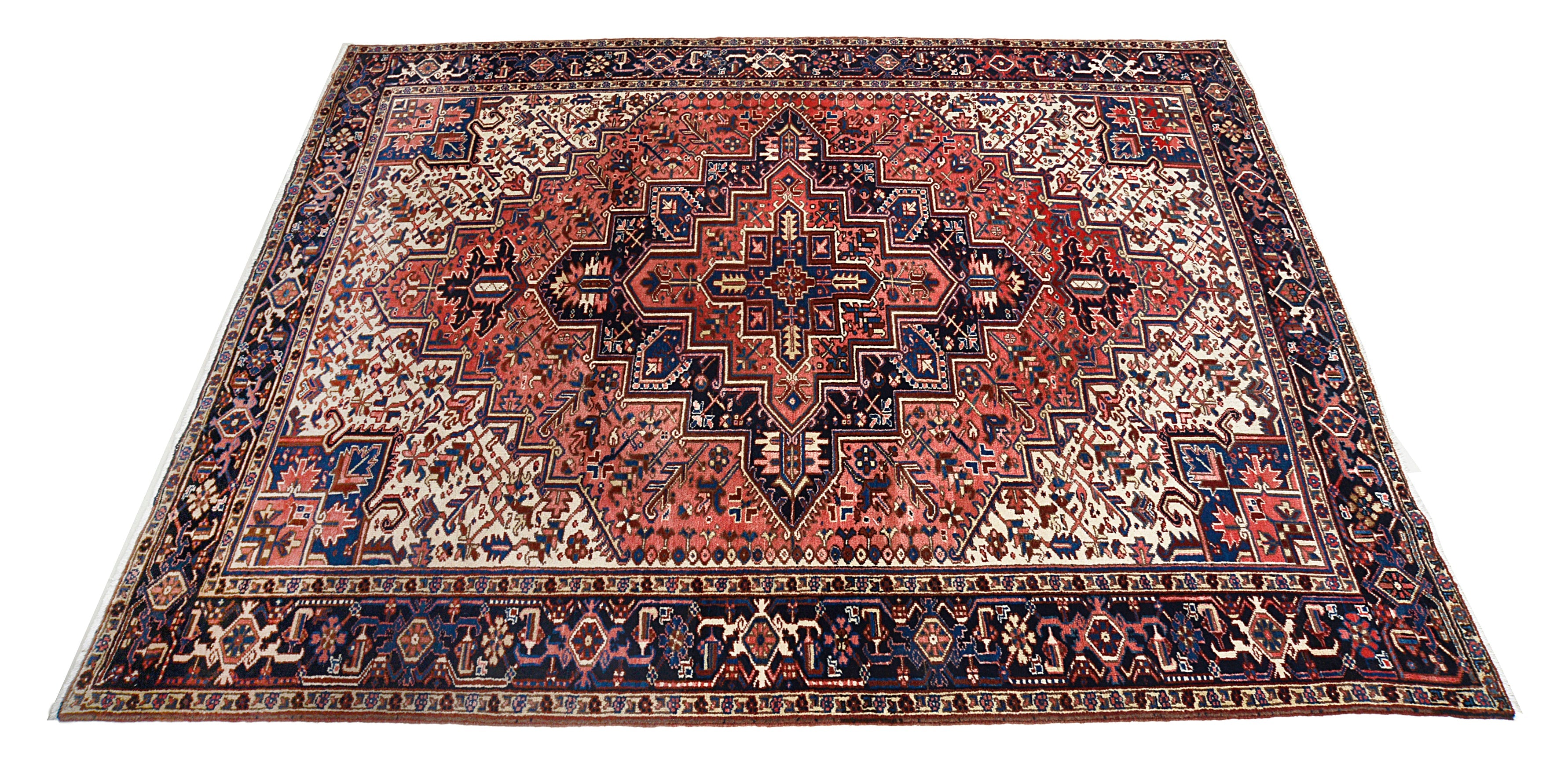 Hand-knotted vintage Heriz carpet with bold central medallion and rich red field