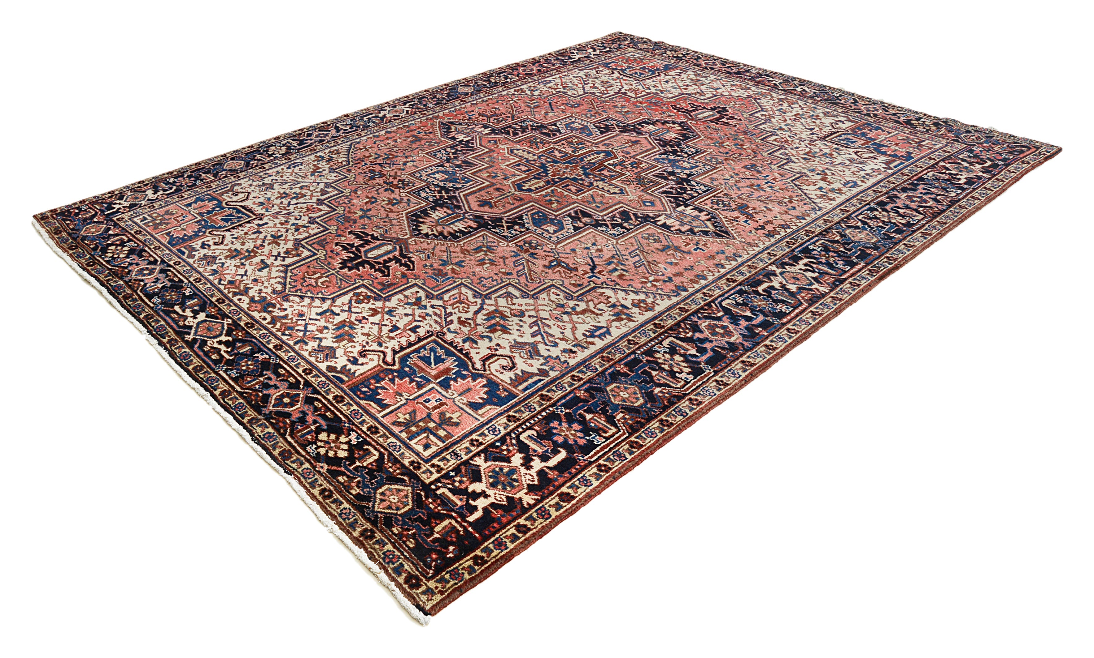 Large vintage Heriz carpet featuring geometric design and contrasting blue border
