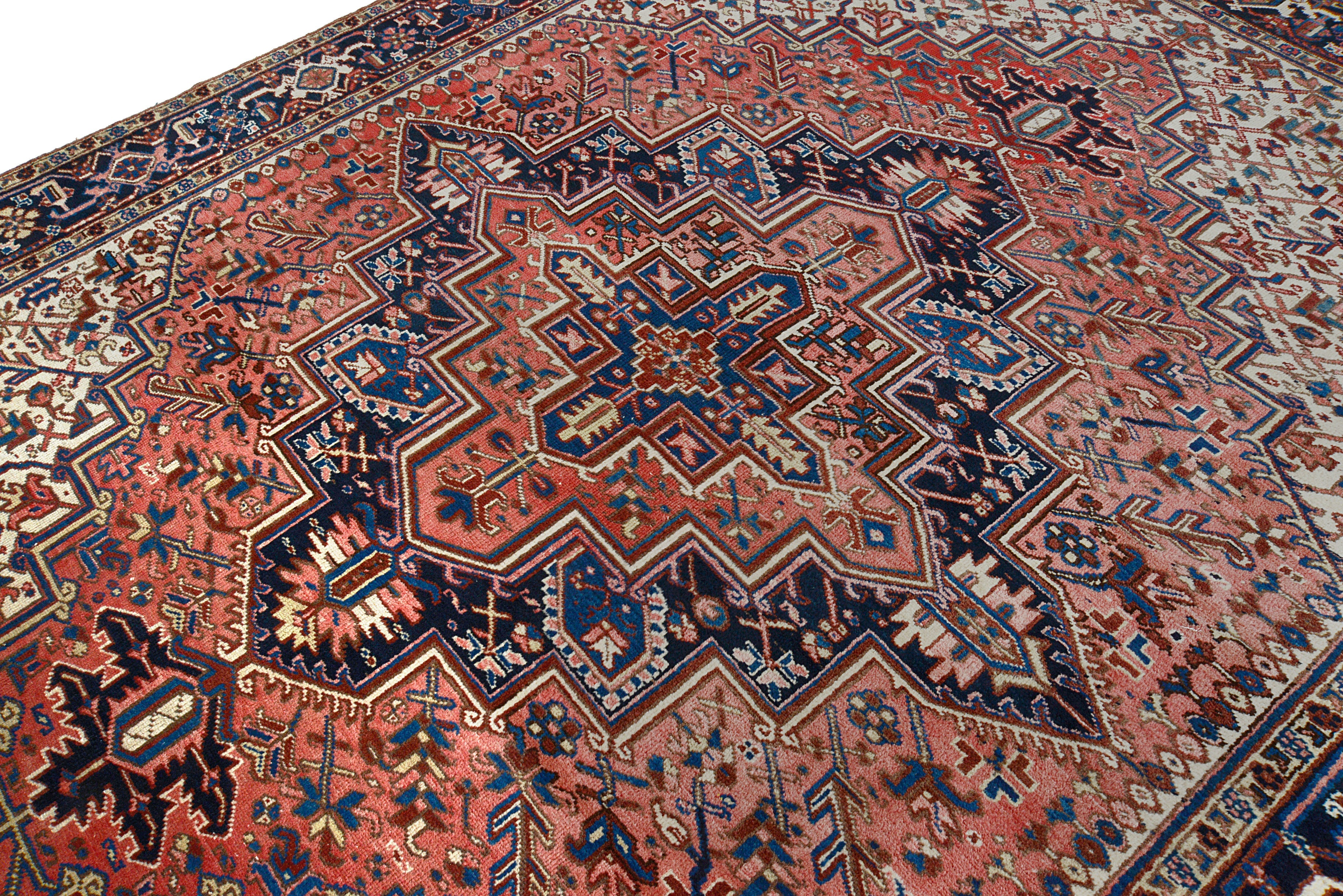 Close-up details of vintage Heriz carpet showing wool texture, motifs, and natural patina