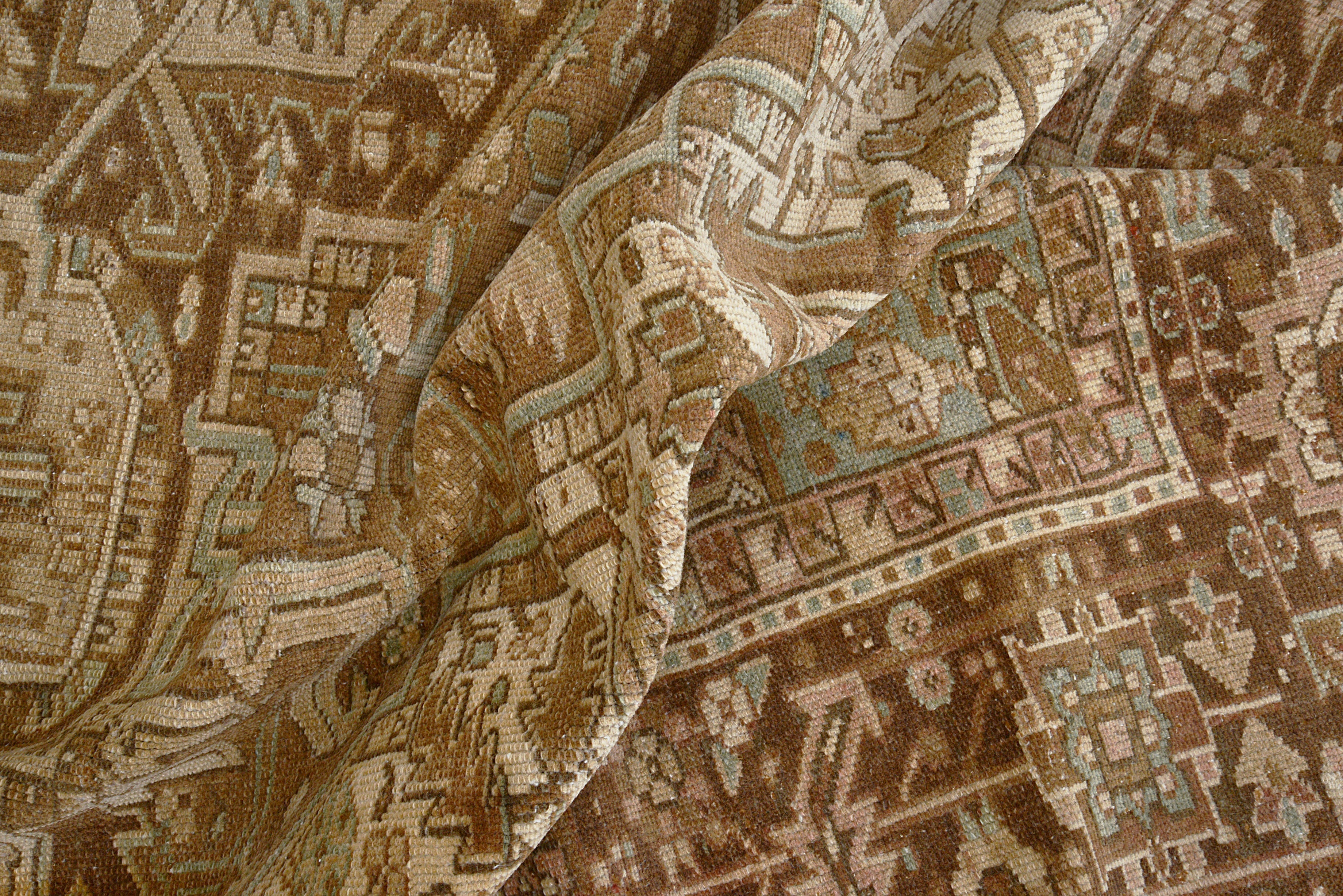 Close-up details of vintage Persian Heriz carpet showing wool texture, motifs, and natural patina