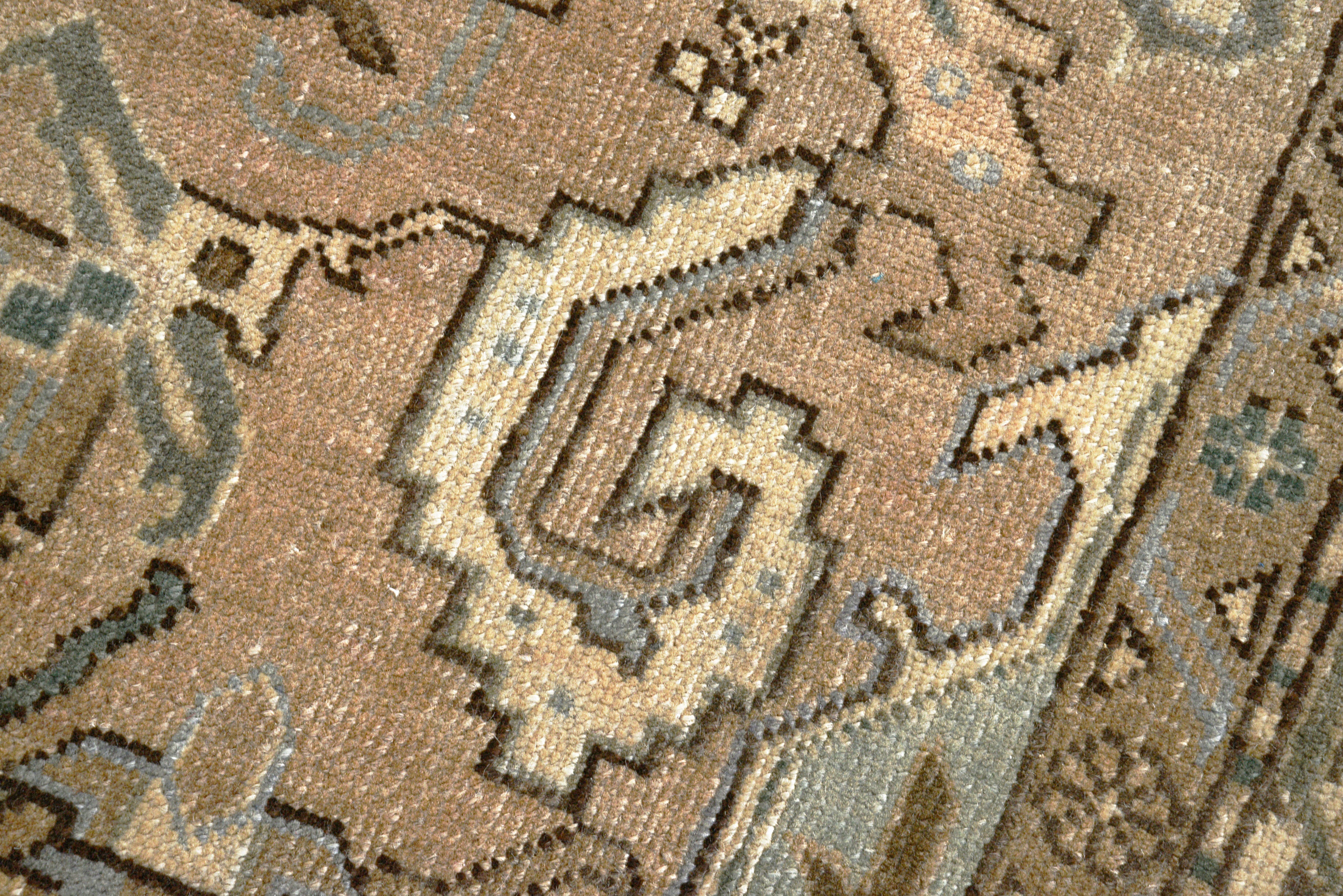 Close-up details of vintage Persian Heriz rug showing wool texture, motifs, and natural patina