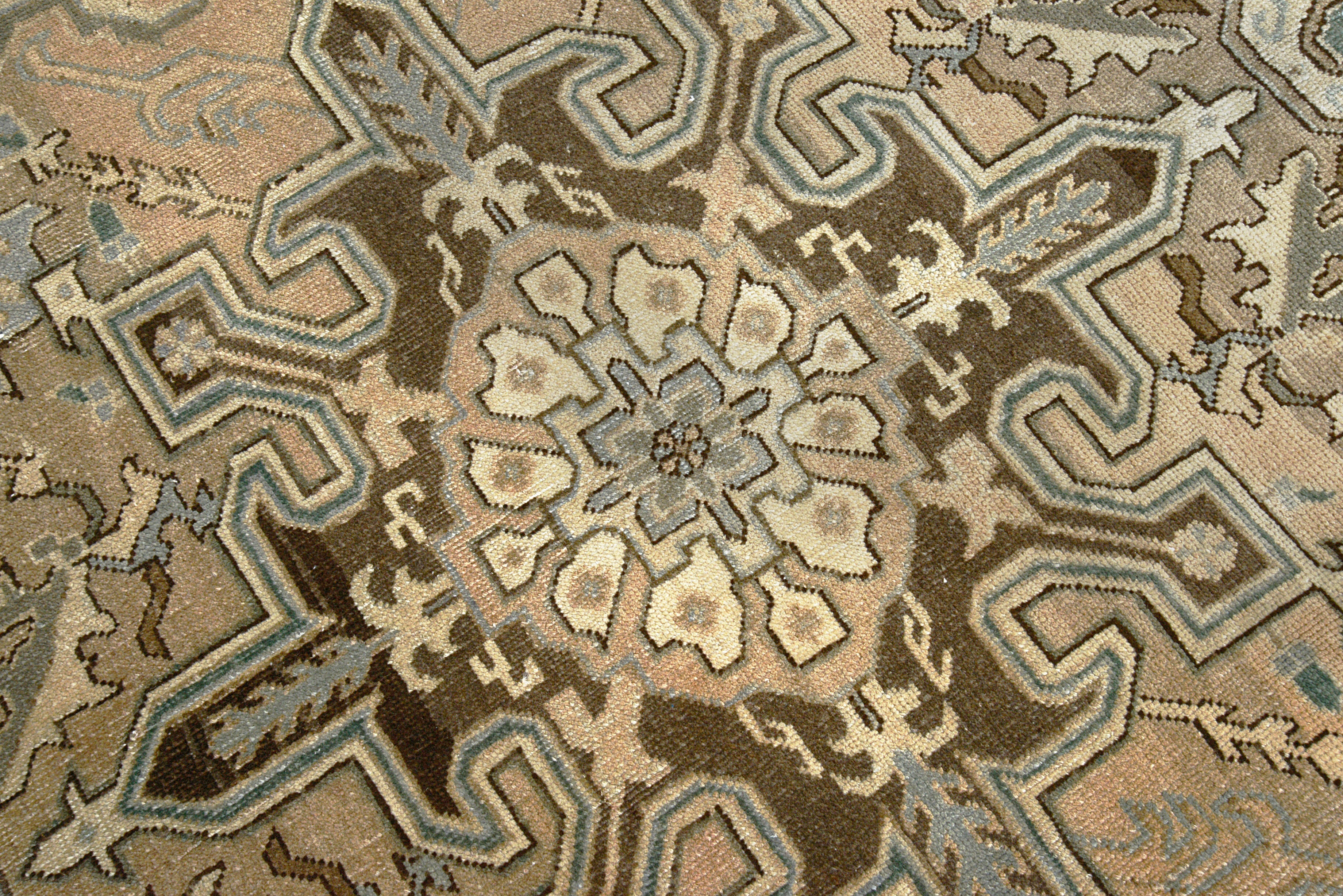 Close-up details of vintage Persian Heriz rug showing wool texture, motifs, and natural patina