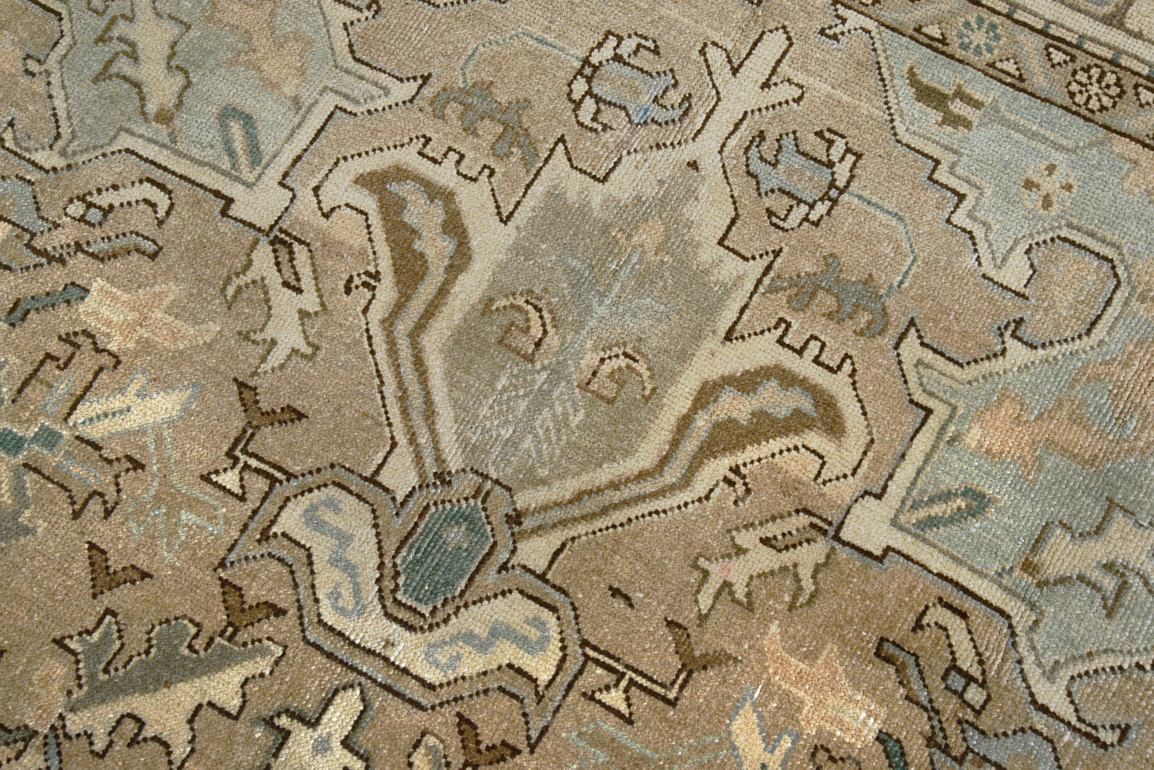 Close-up details of vintage Persian Heriz rug showing wool texture, motifs, and natural patina
