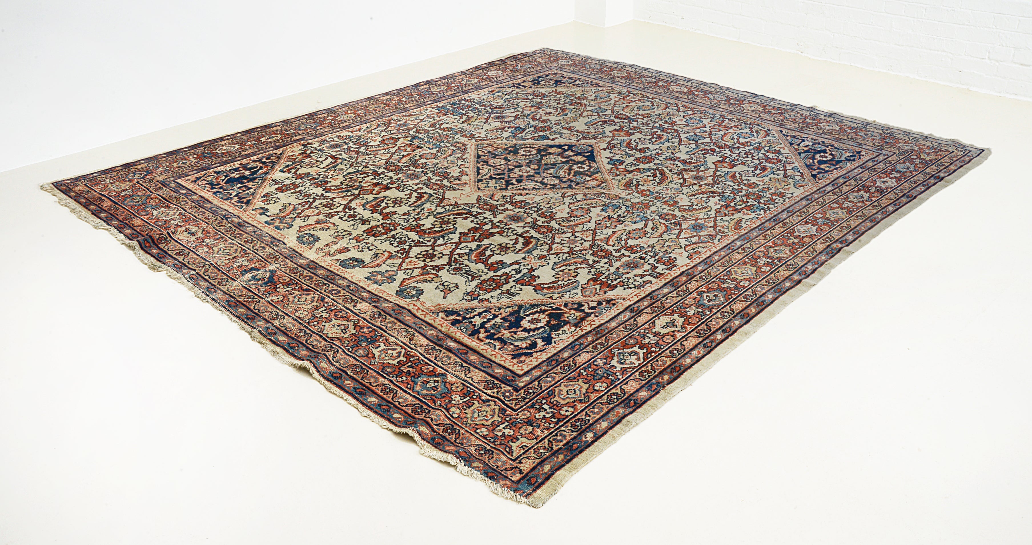 Close-up of antique Mahal carpet field highlighting floral pattern and natural patina