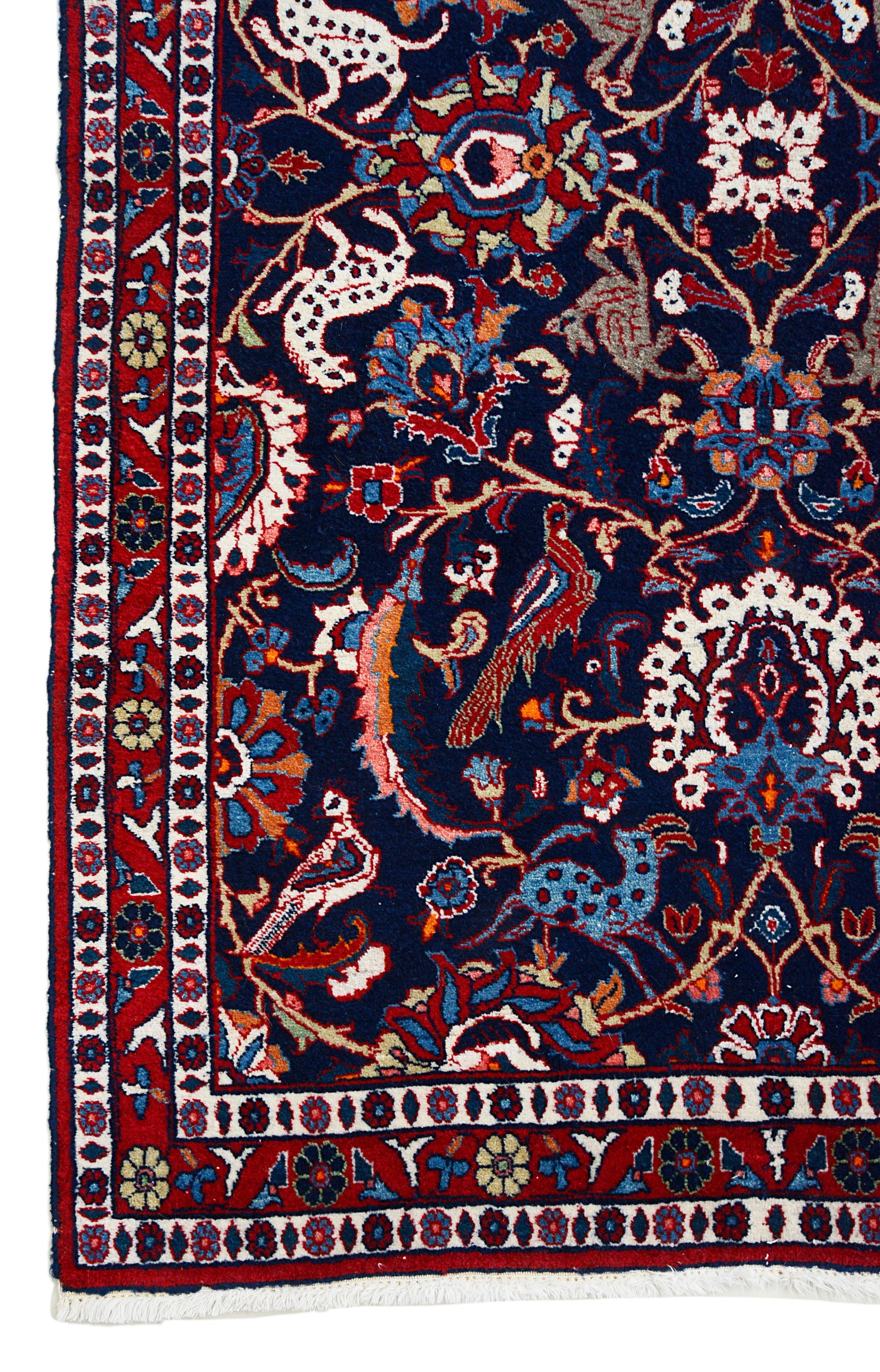 Vintage Persian Mashhad rug corner detail showing hand-knotted wool and floral border design